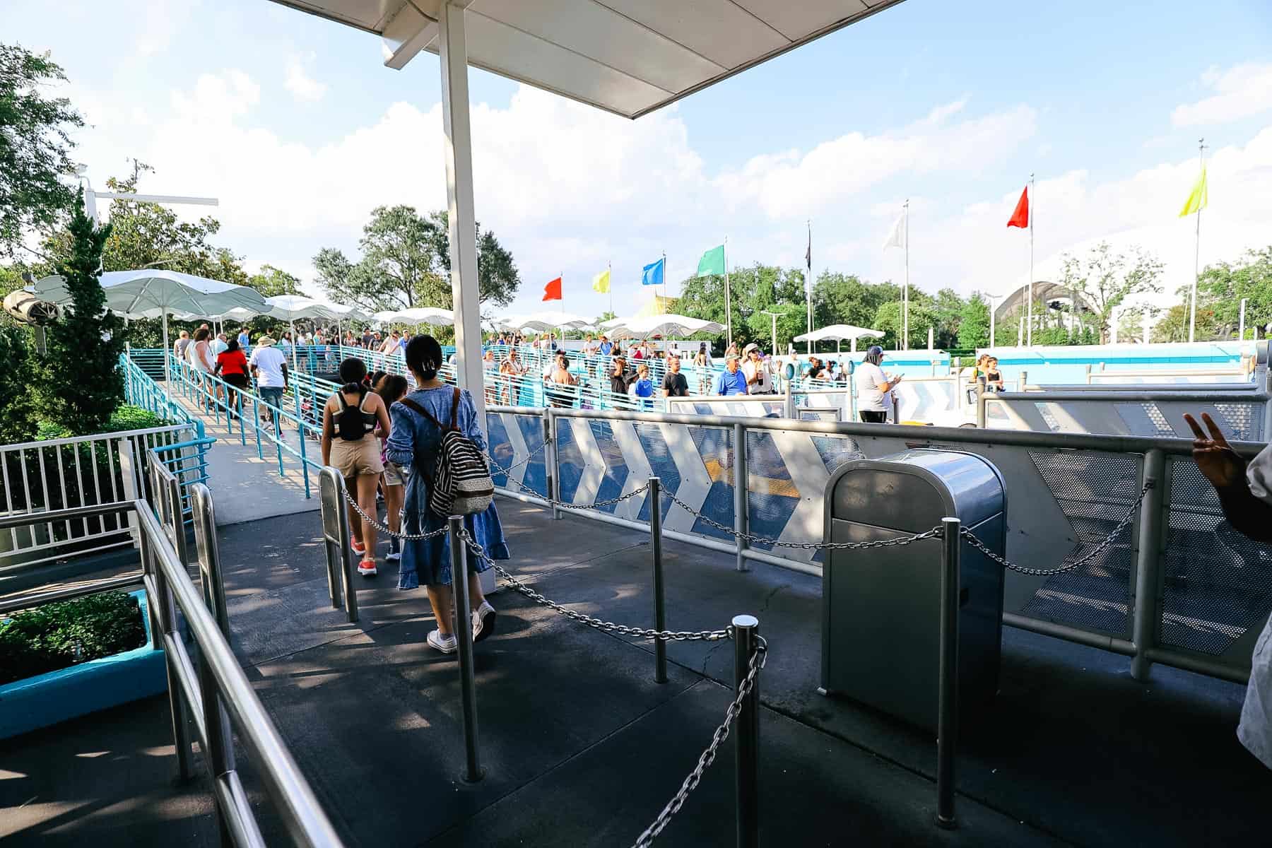 Guests standing in line to ride the Tomorrowland Speedway. 