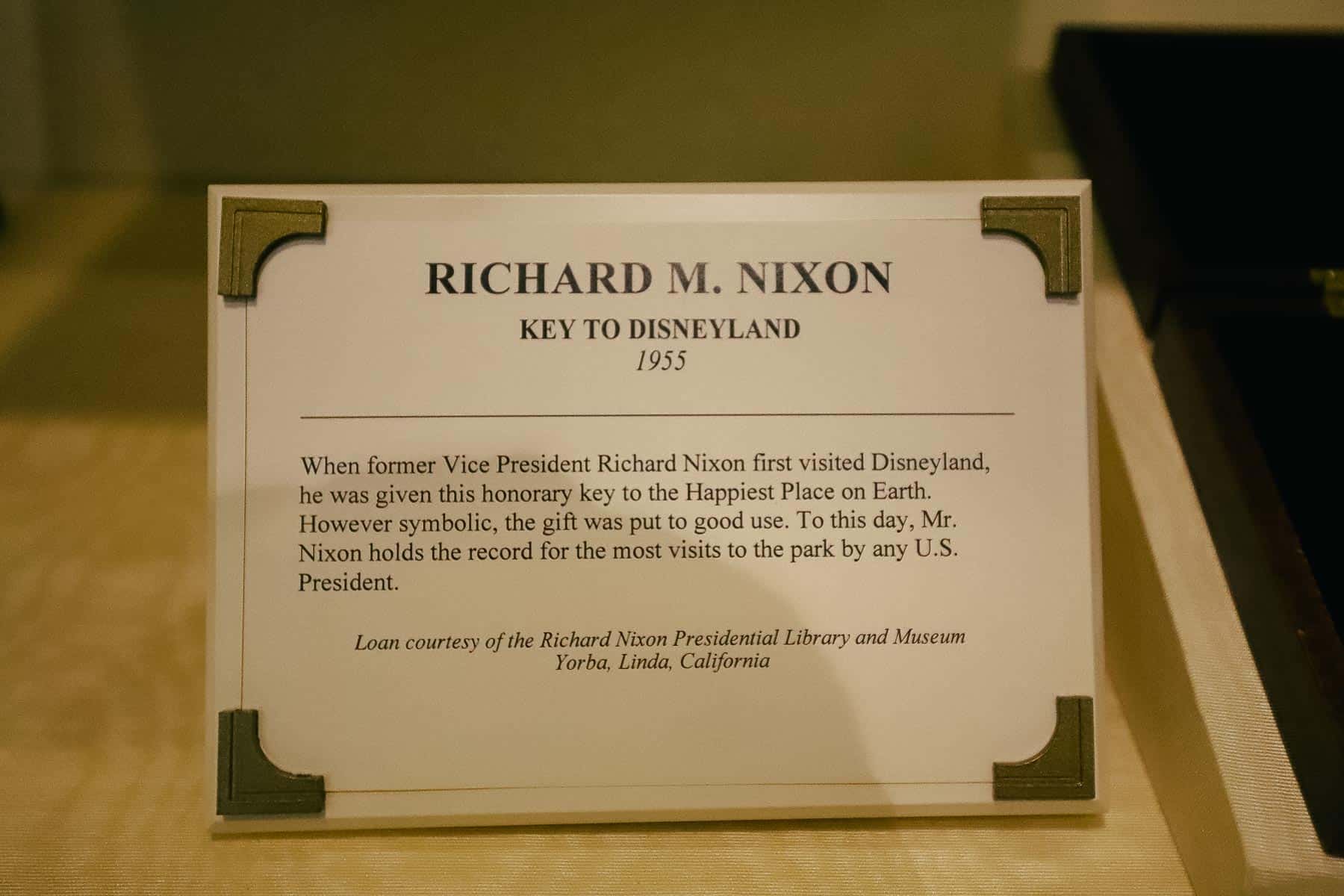 A sign that tells how Richard Nixon visited Disneyland often and held the record for the most visits to the park by any U.S. President. 