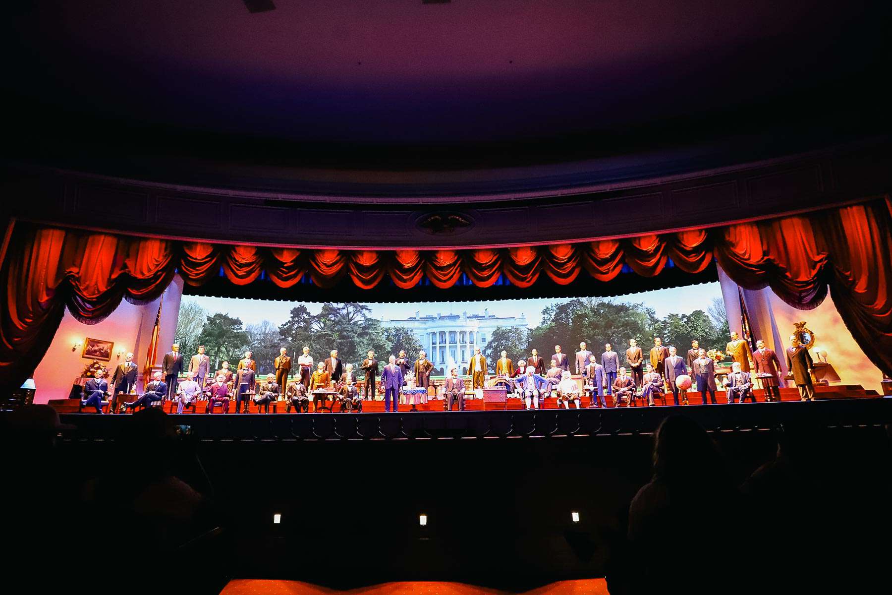 curtain raises to reveal animatronic figures of the presidents 