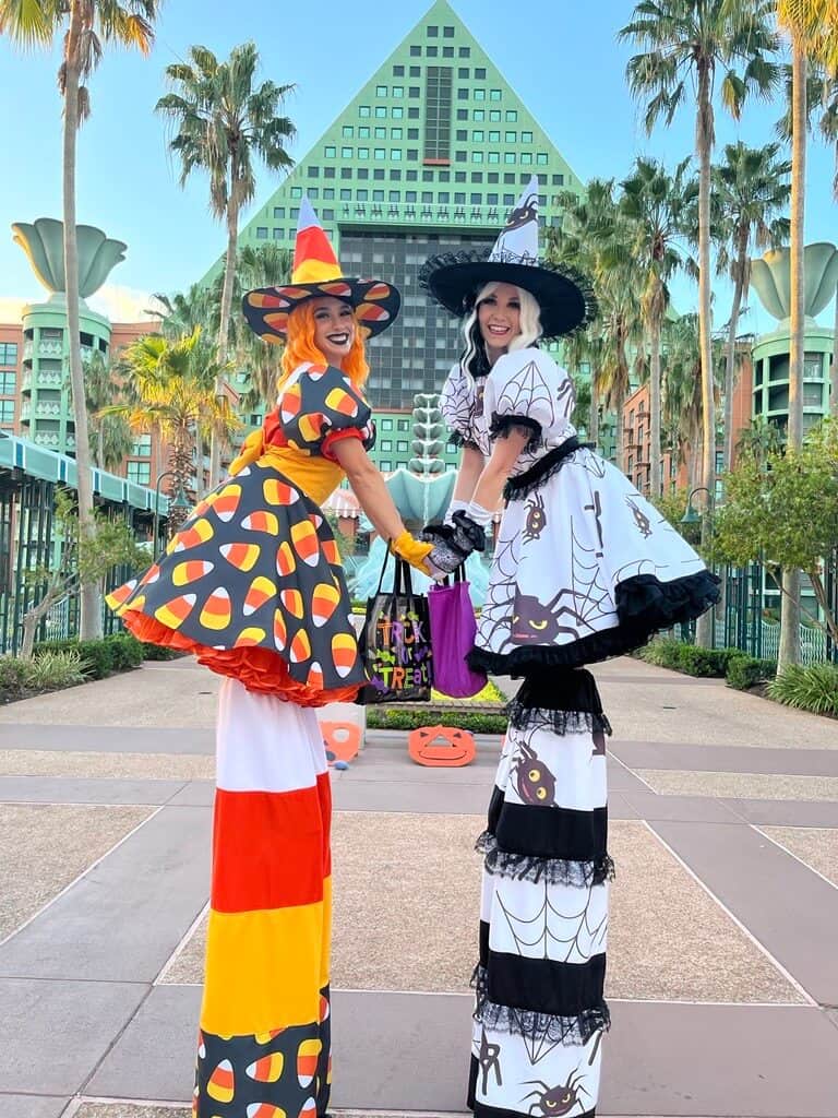 two stilt walkers entertaining guests at Disney's Swan and Dolphin on Halloween