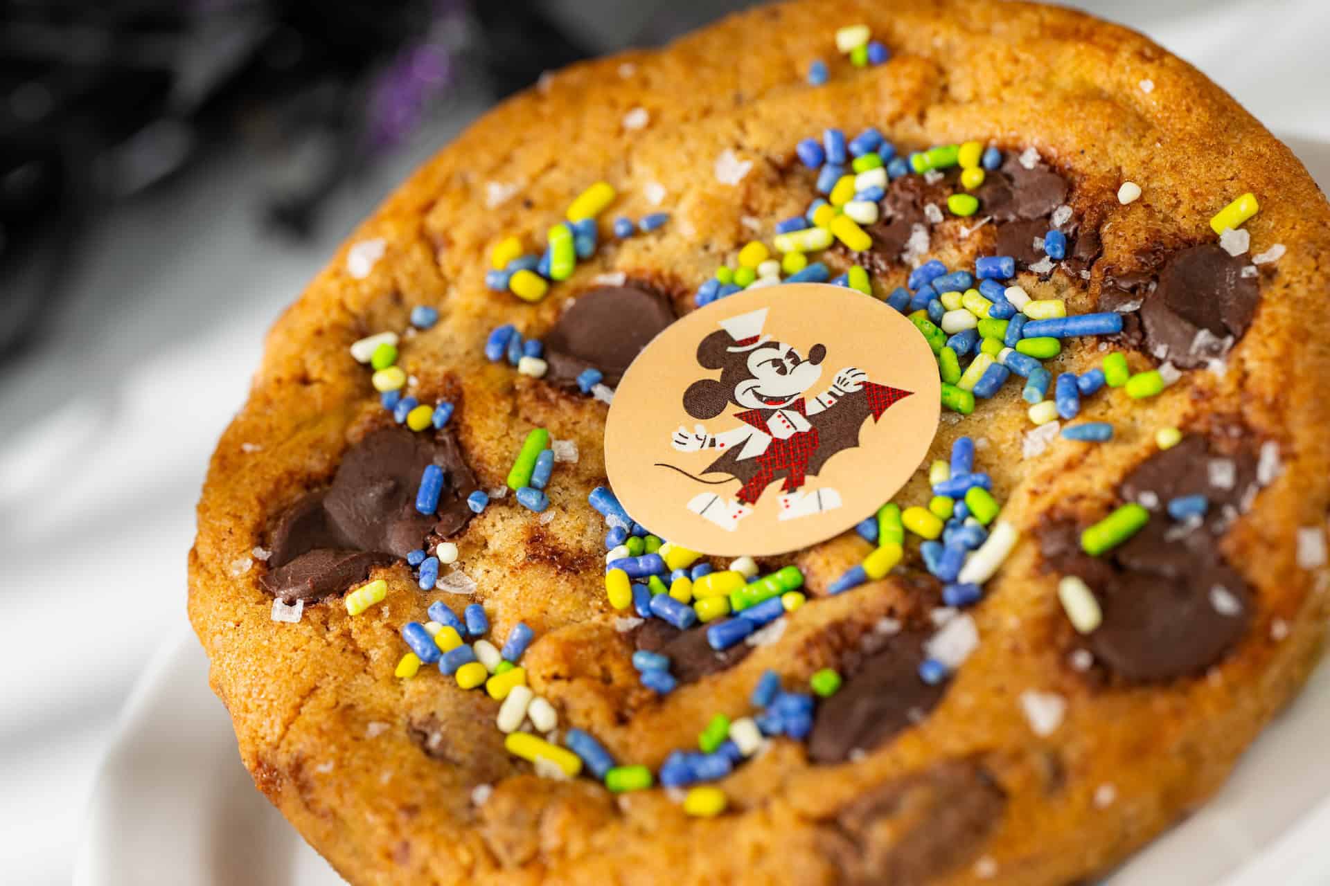 a chocolate chip cookie with Mickey Mouse and sprinkles