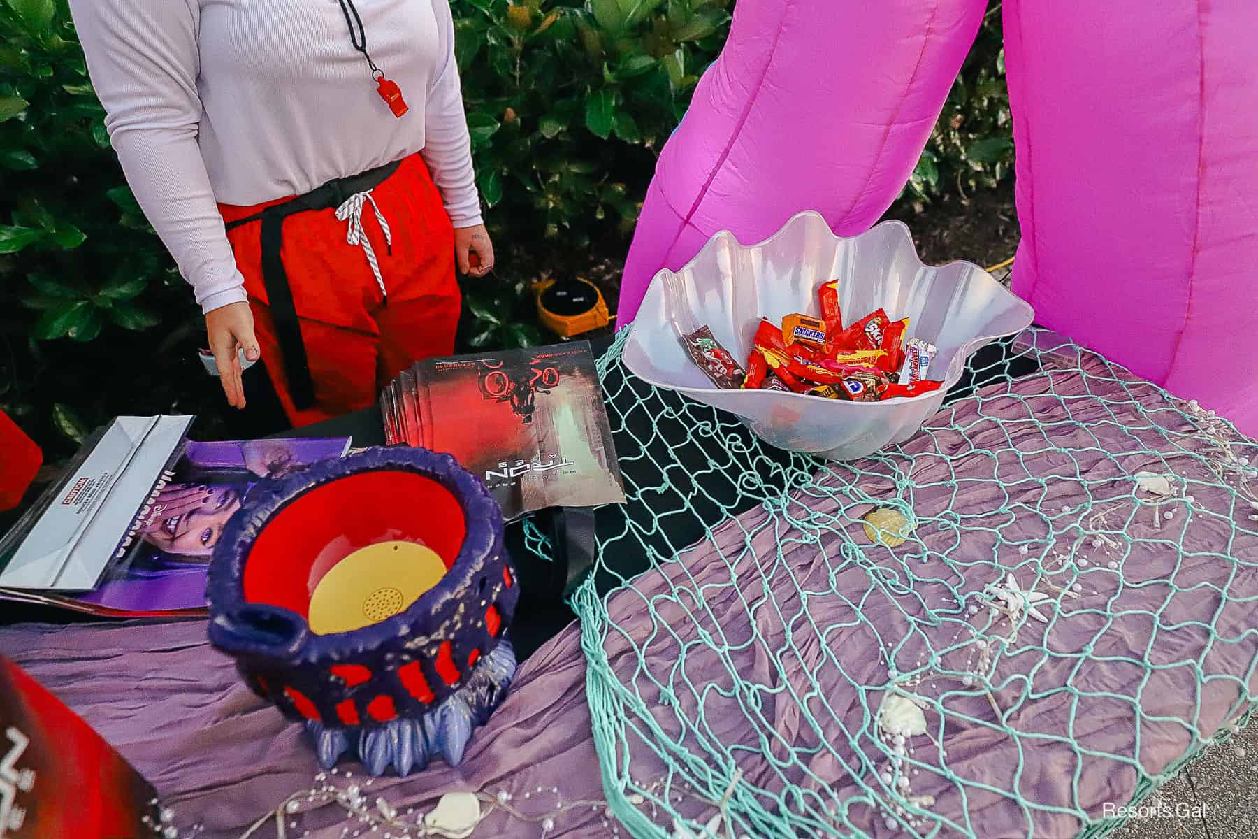 a cast member handing out candy on Halloween