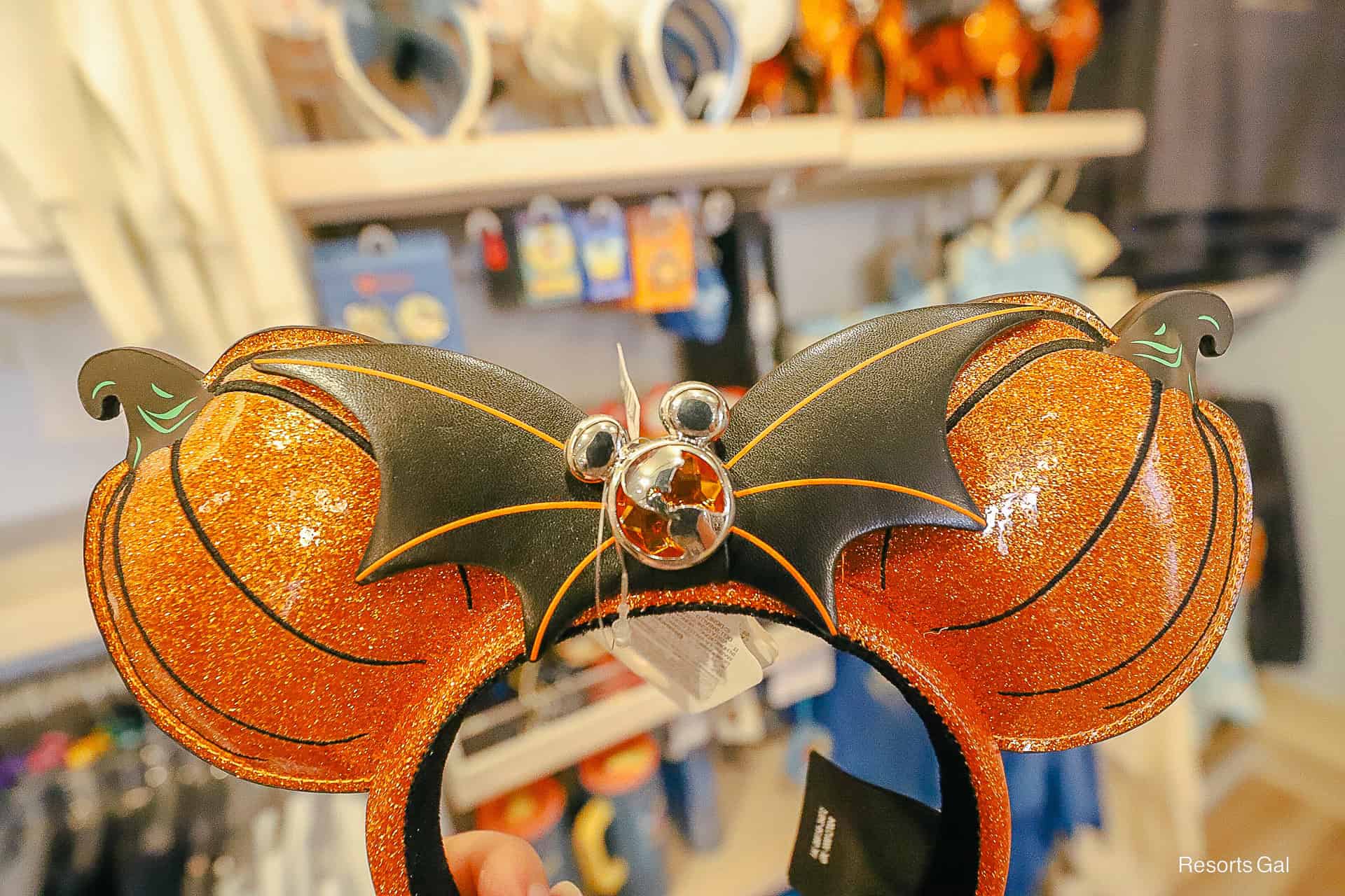 front of the 2026 DVC ear headband with DVC globe logo in Halloween colors