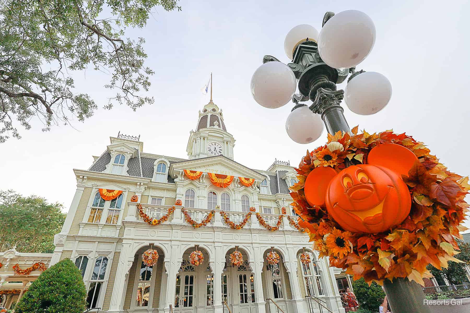 a Mickey-shaped pumpkin on a wreath at Magic Kingdom