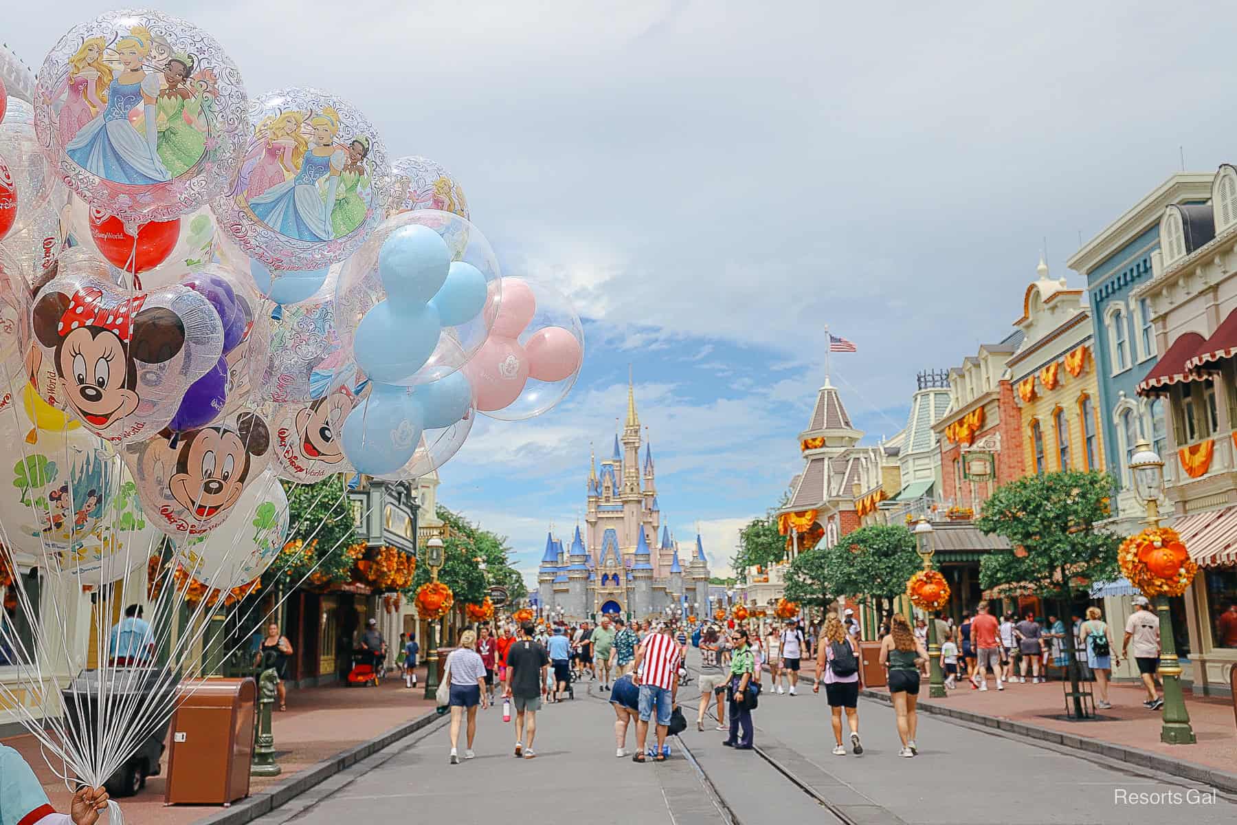 a Halloween shot down Main Street U.S.A. with a balloon bouquet on the left side 
