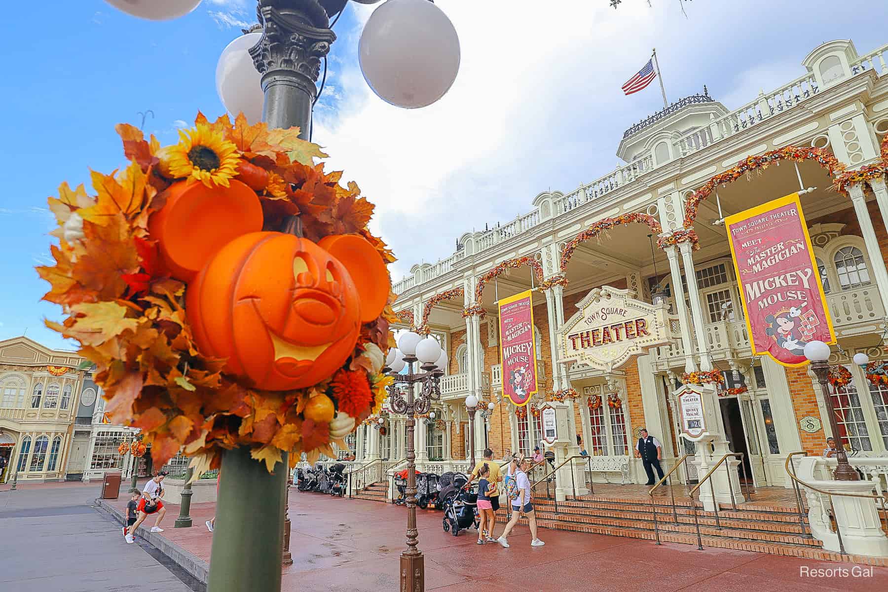 side angle with a pumpkin wreath and Town Square Theater in the backdrop 