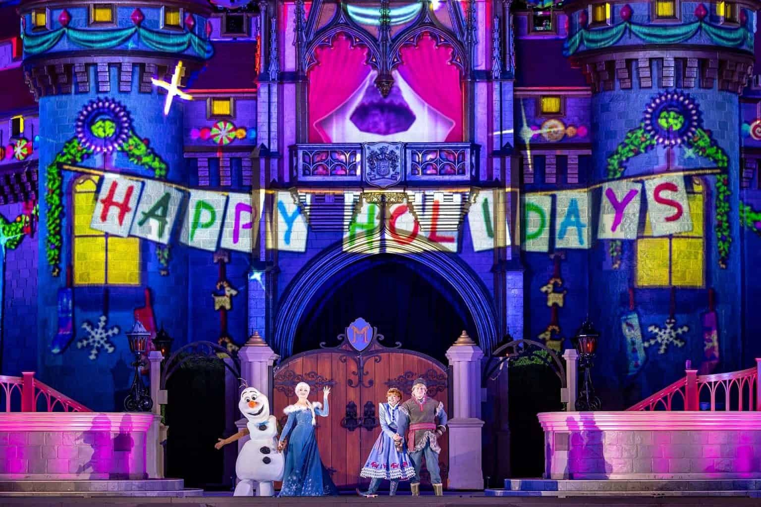 Olaf, Elsa, Anna, and Kristoff on stage during the Christmas Party