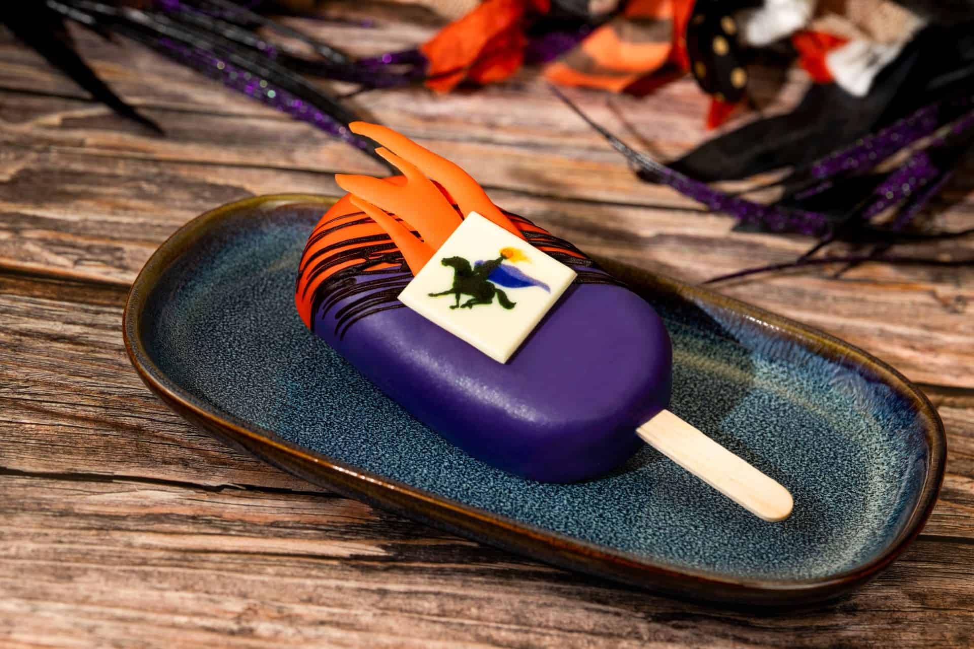a purple popsicle with a white chocolate piece air brushed with the Headless Horseman