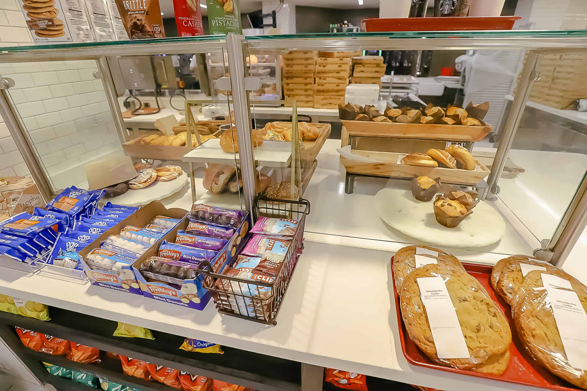a pastry case with various muffin, cookies, and danishes 