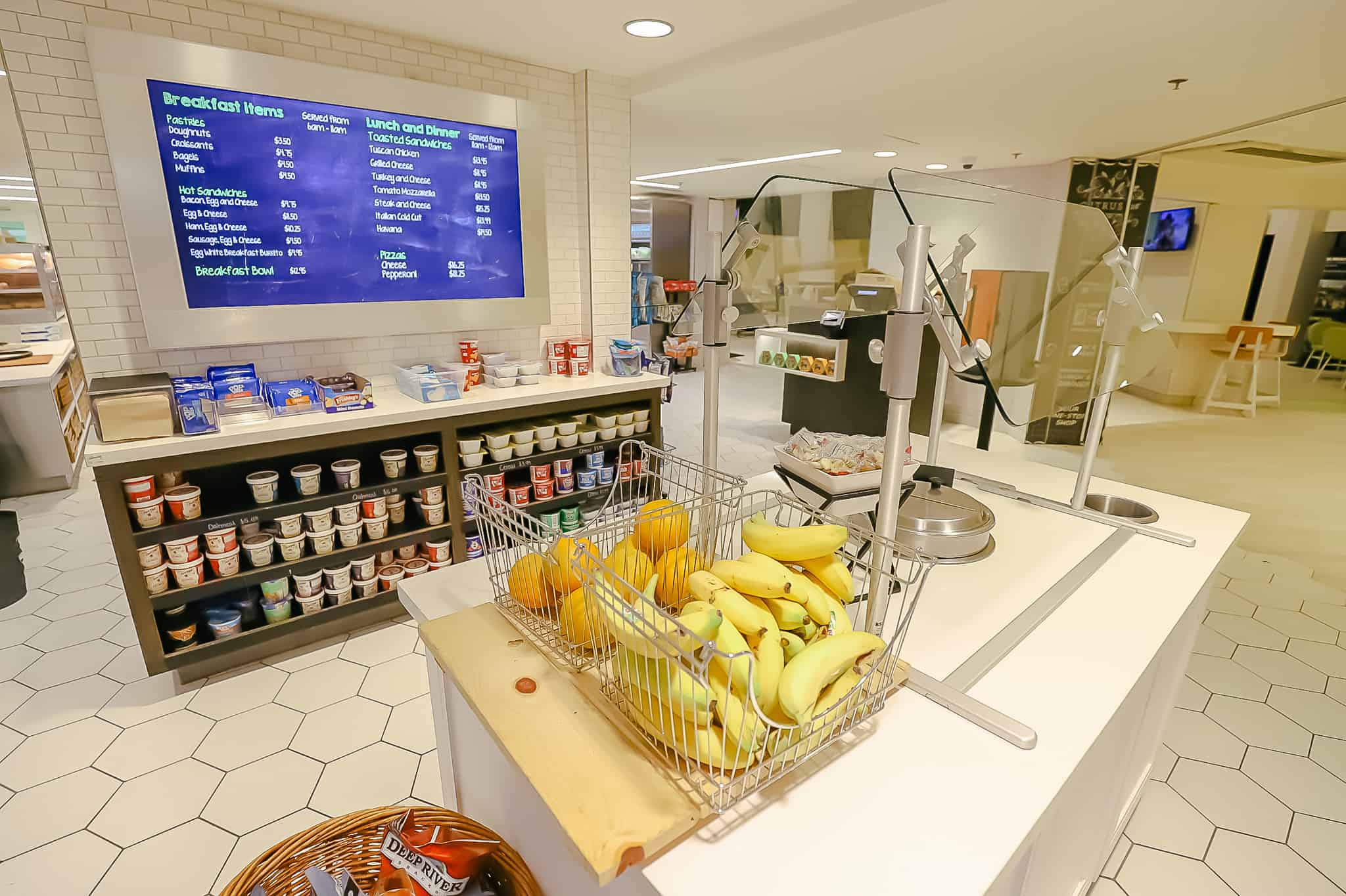 bananas, oranges, and a canister with the soup of the day 