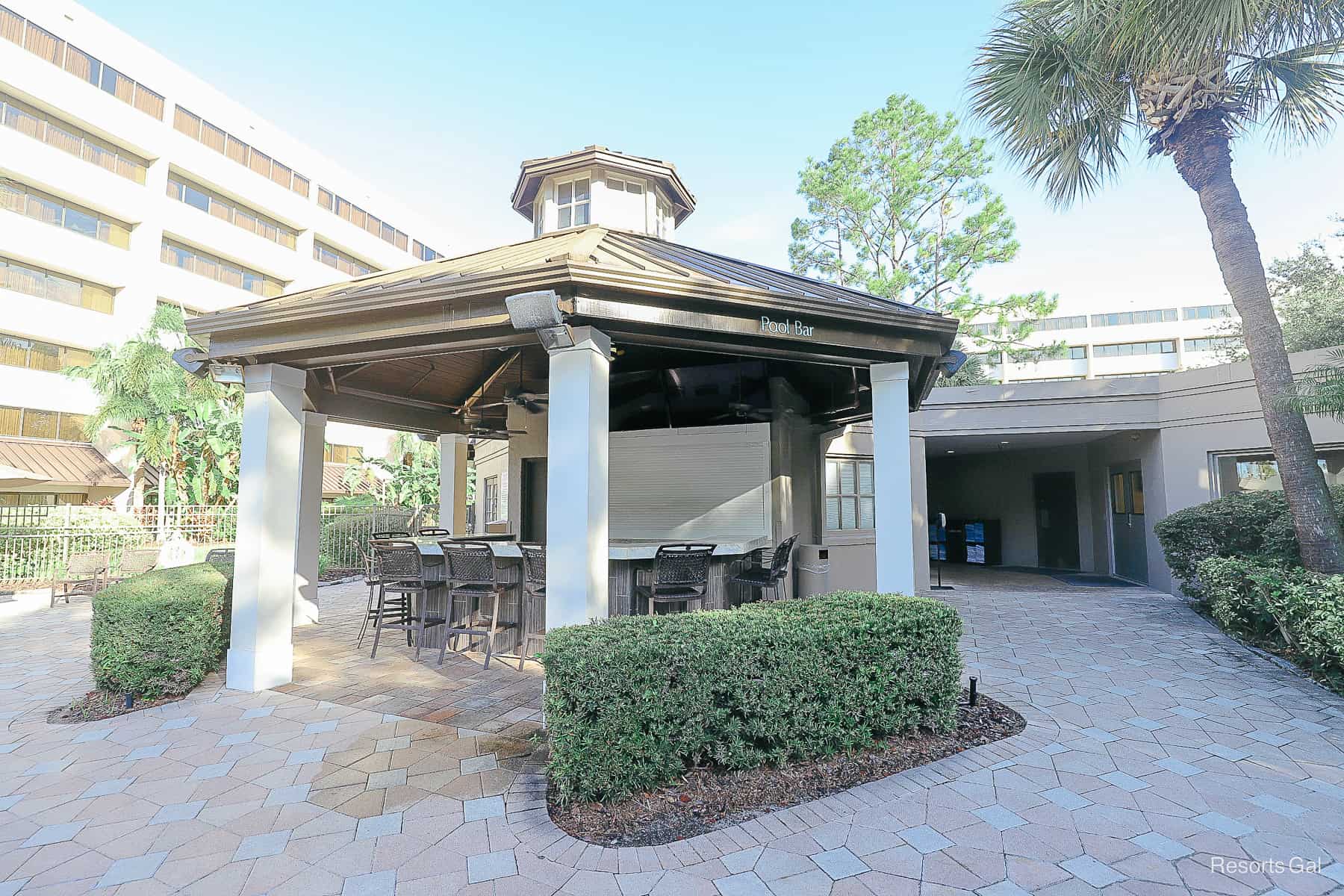 a covered bar and pavilion by the pool 