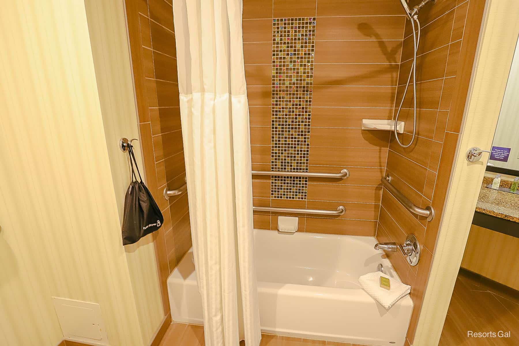 a tile shower and combined bathtub in the Doubletree Suites 