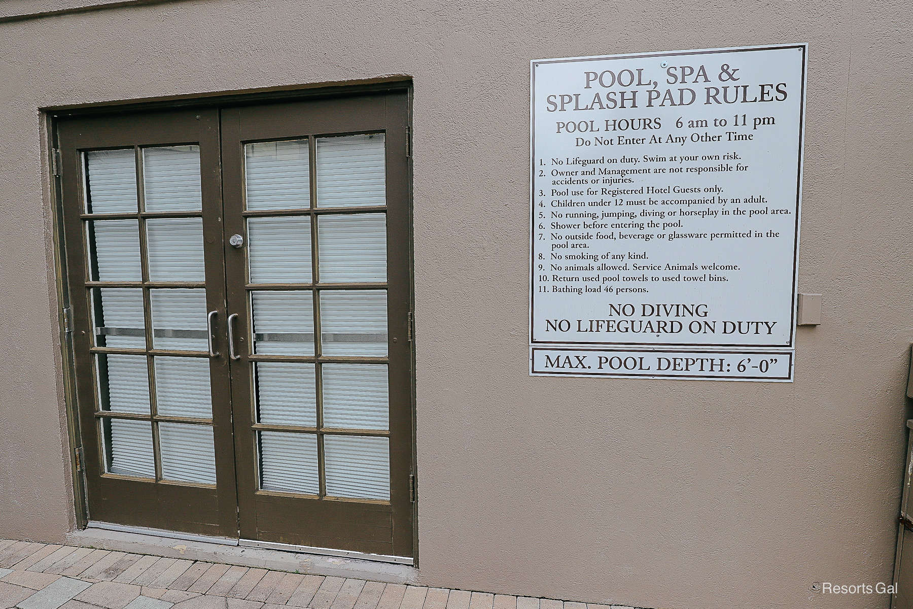 a posted set of rules and hours for guests using the pool area 