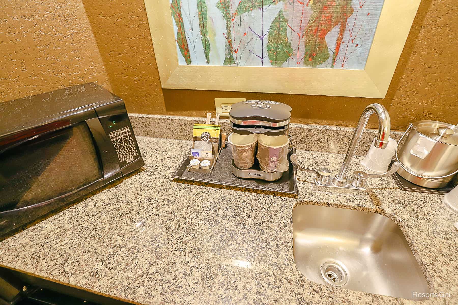 a microwave, an individual cup coffee maker, and a small sink in the room at Hilton Doubletree Disney Springs 