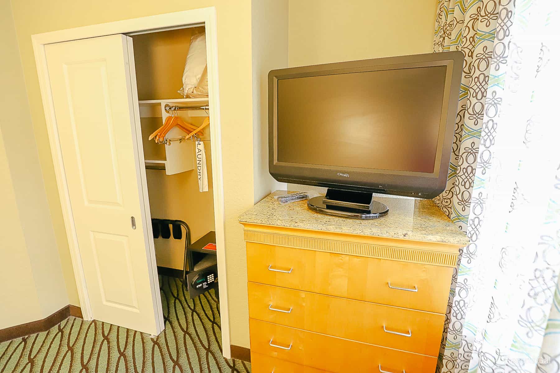 an older television sits on a chest of drawers 