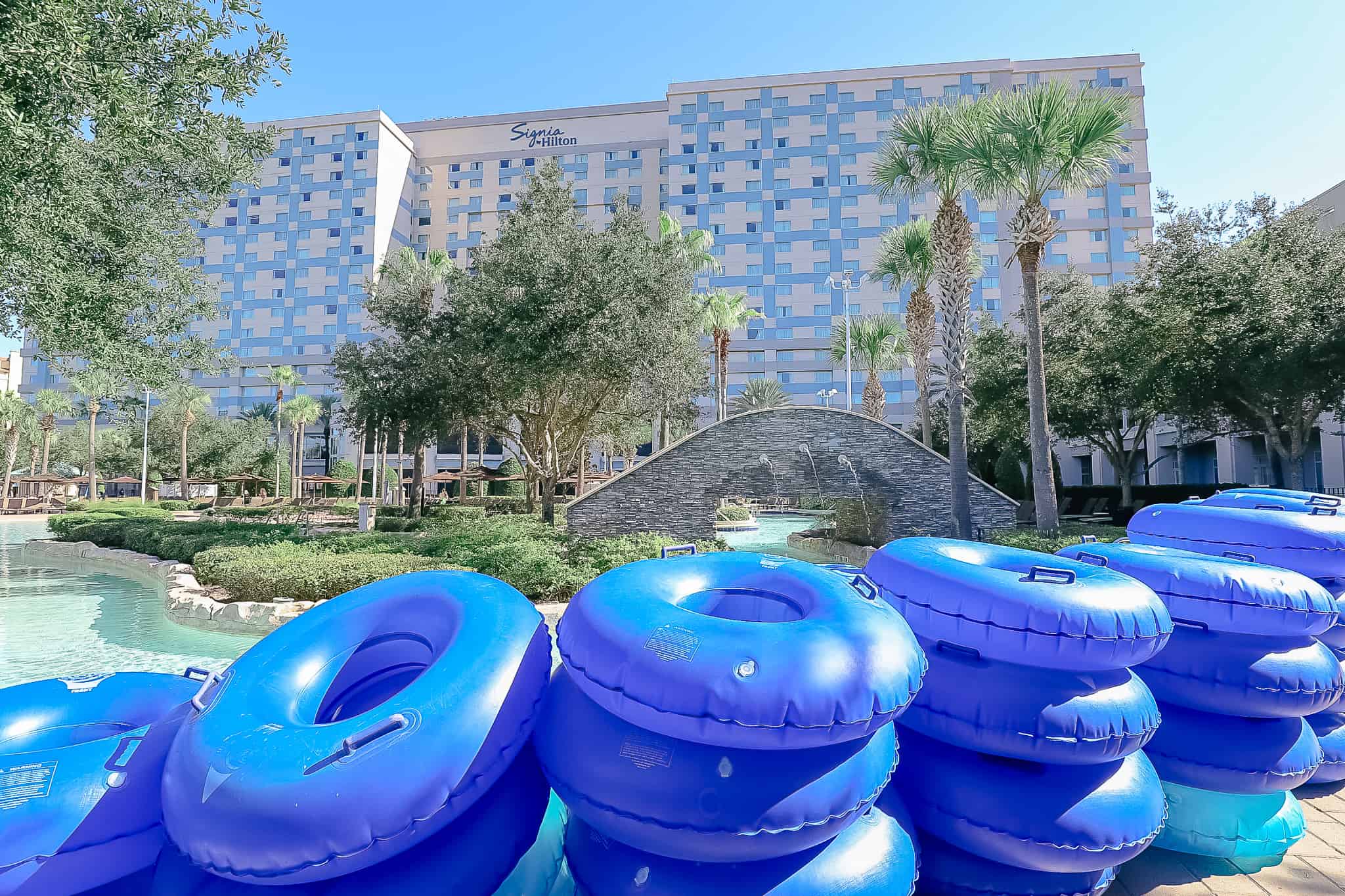 stack of inner tubes in front of the pool 