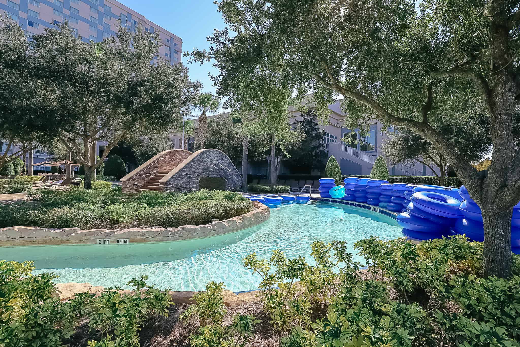 portion of the lazy river with the hotel in the background 