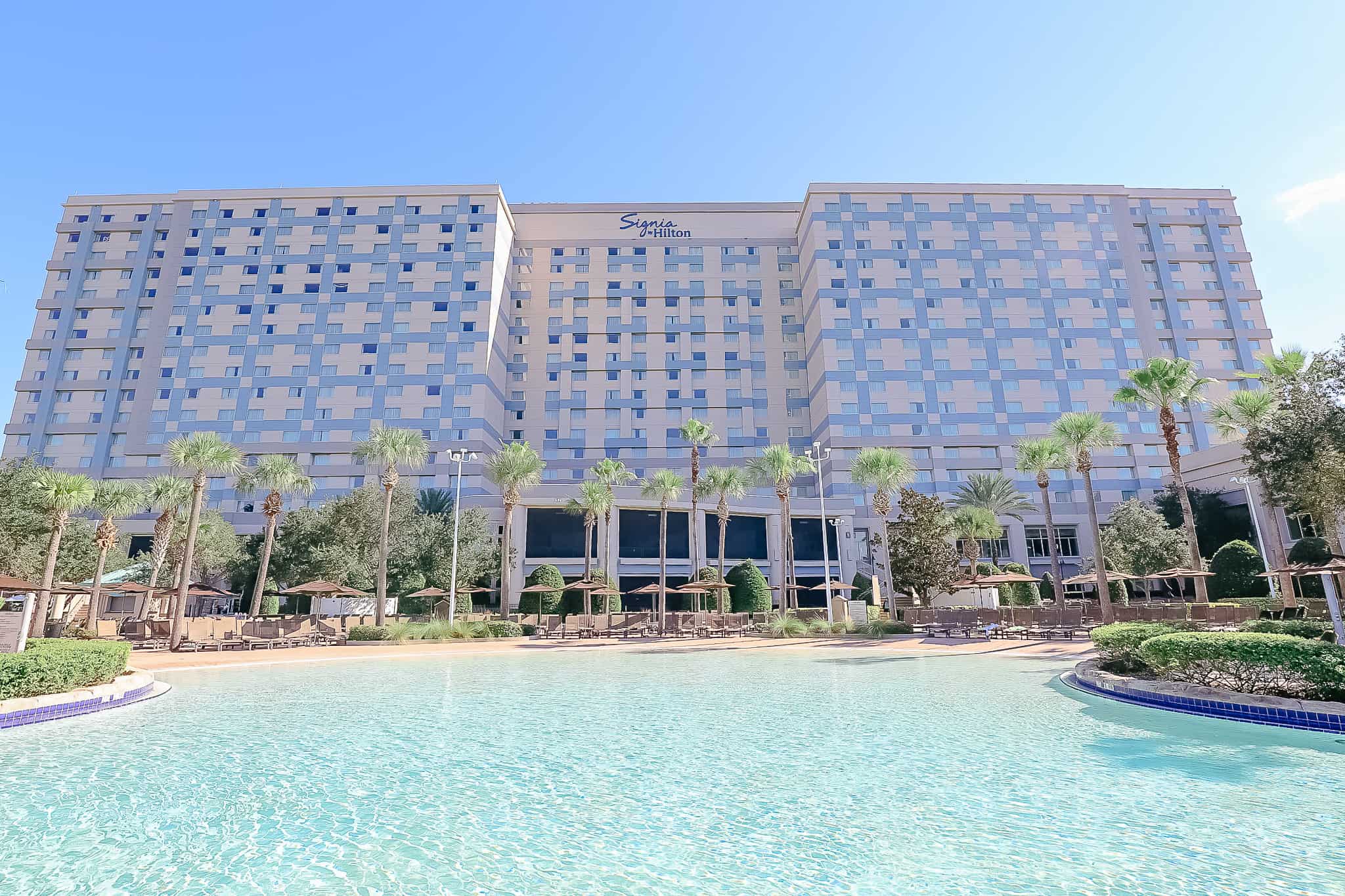 a large image that shows the zero entry pool area and the hotel in the backdrop 