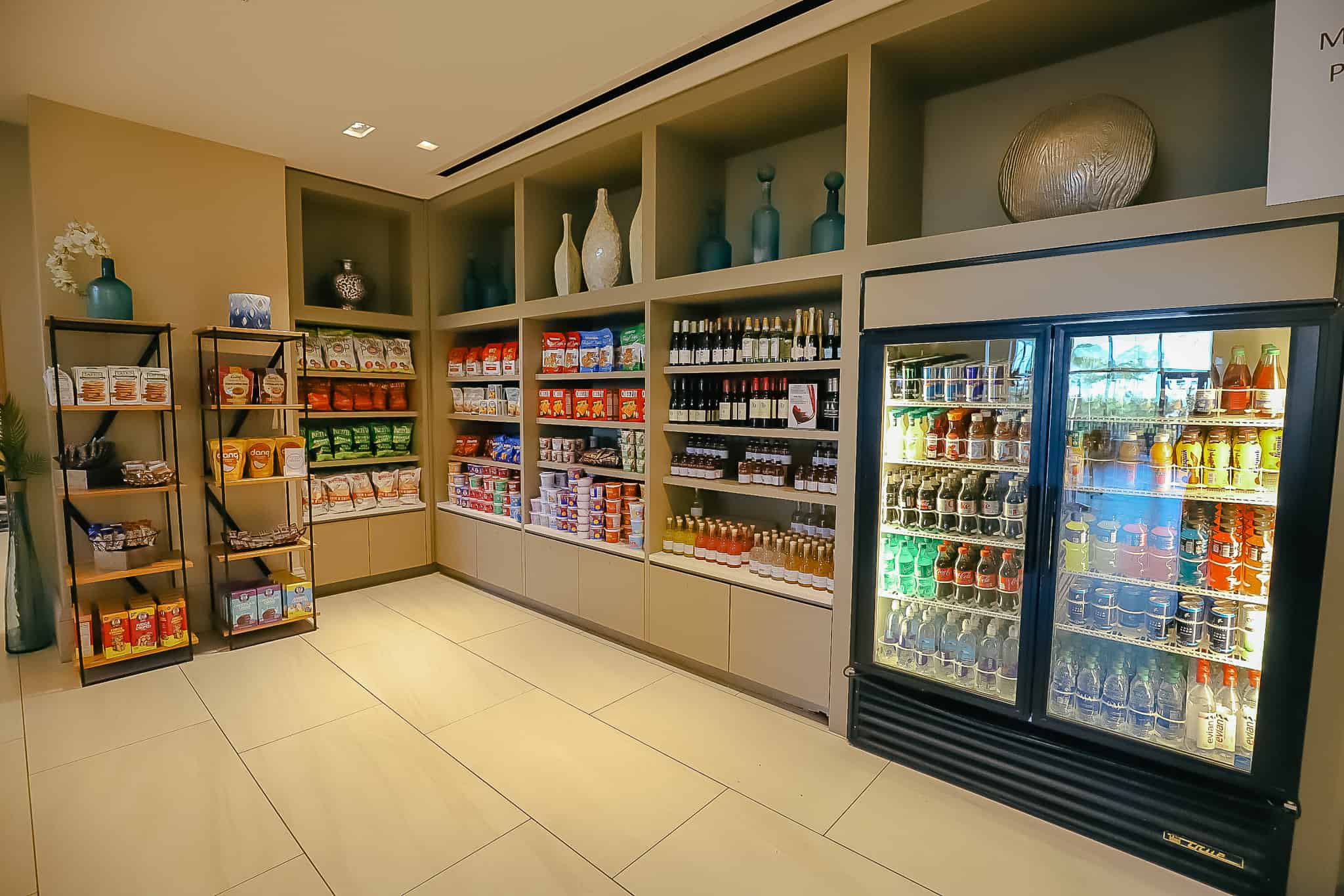 refrigerated cases with beverages and snack items on shelves 