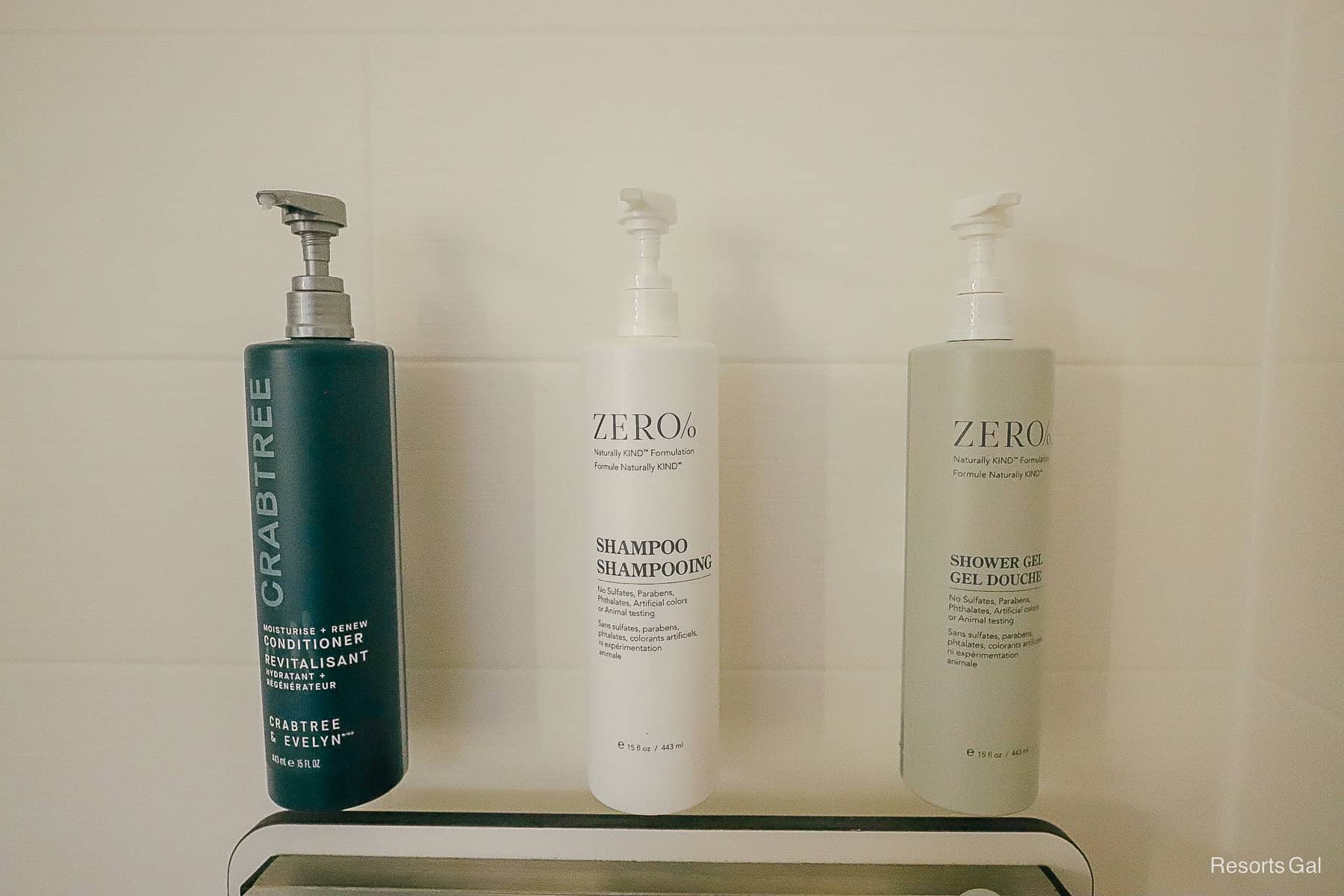 conditioners, shampoo, and bath gel in dispenser on the shower wall 