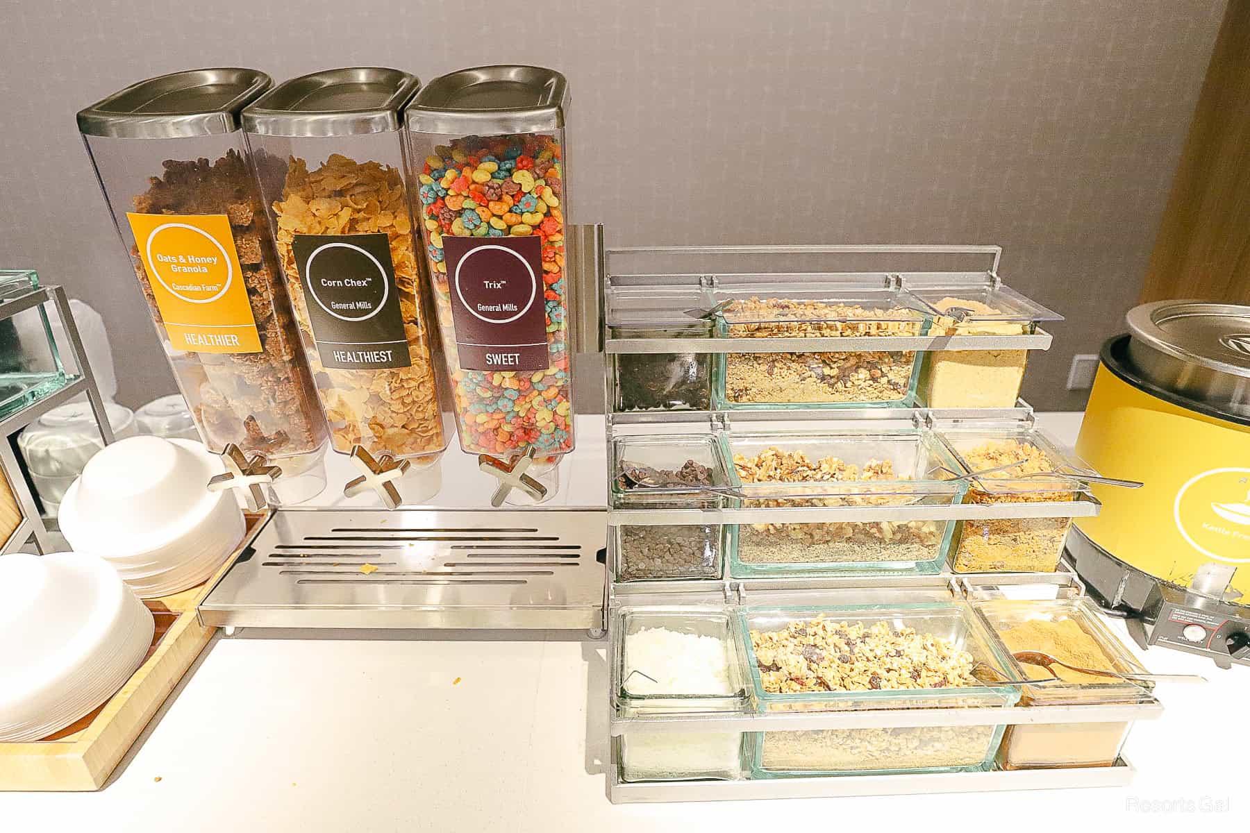 complimentary breakfast station at the Home2 Suites by Hilton Winter Garden featuring cereal and toppings 