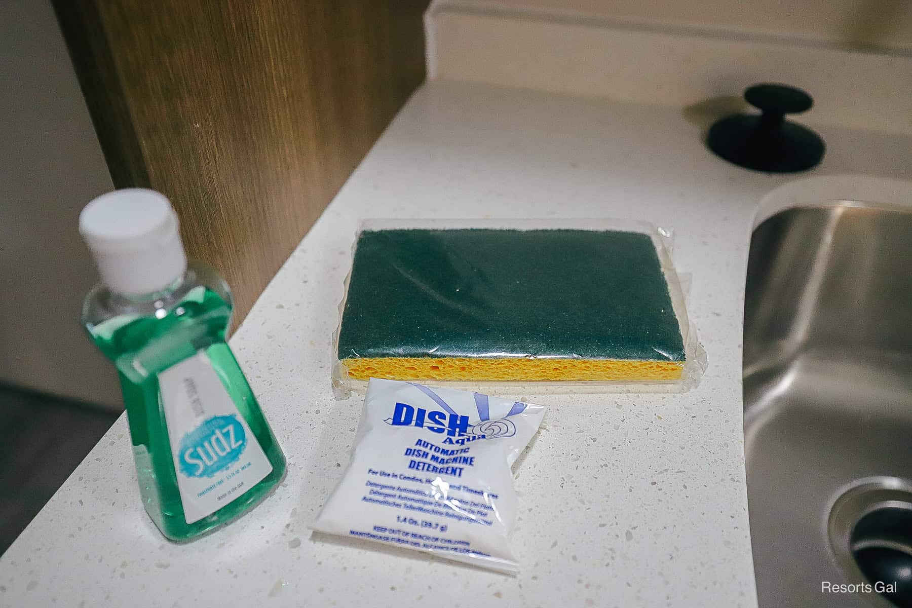 a dish soap and sponge with detergent 