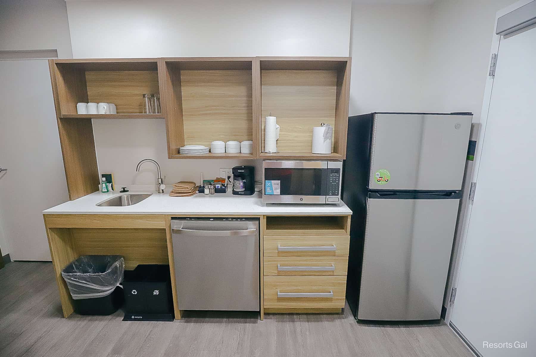 an overview of the entire kitchen with counter space and open cabinets 