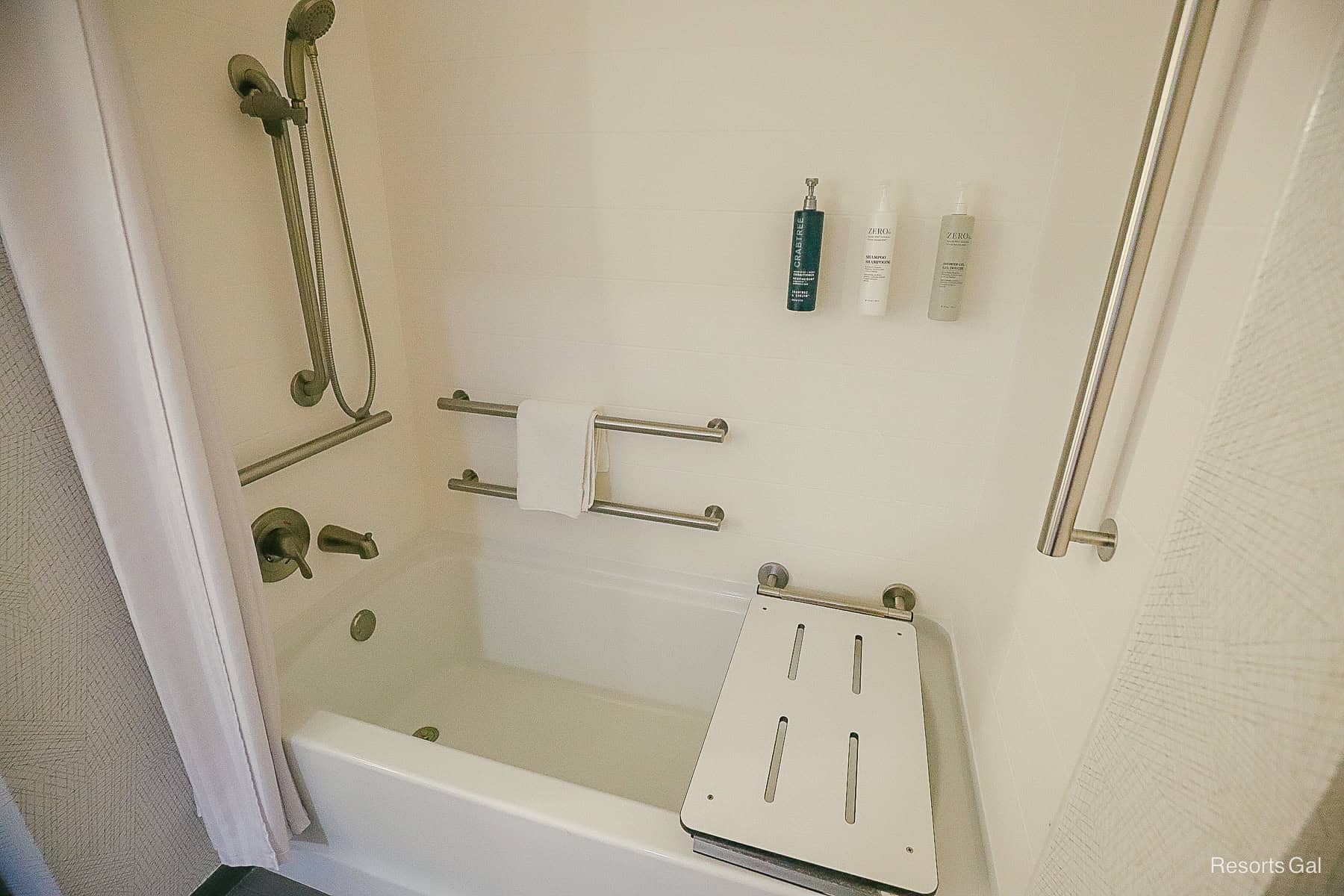 a tub with shower combination that has bench seating folded for those with accessibility needs 