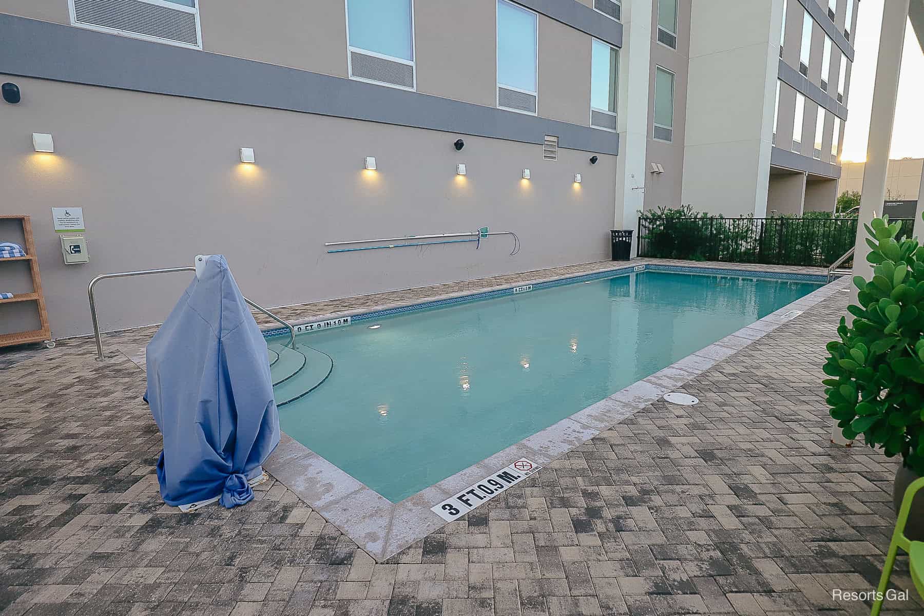 a view of the pool that shows a lift for those with accessibility needs 