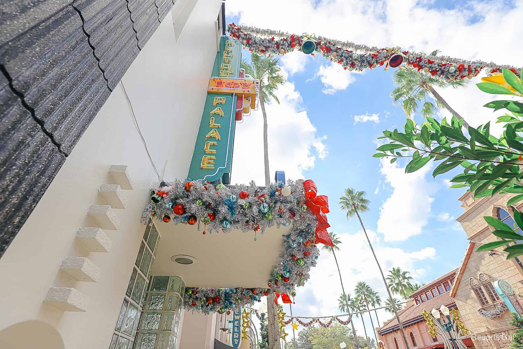 an overhang of a shop on Hollywood Boulevard at Disney's Hollywood Studios covered in Christmas decorations. 