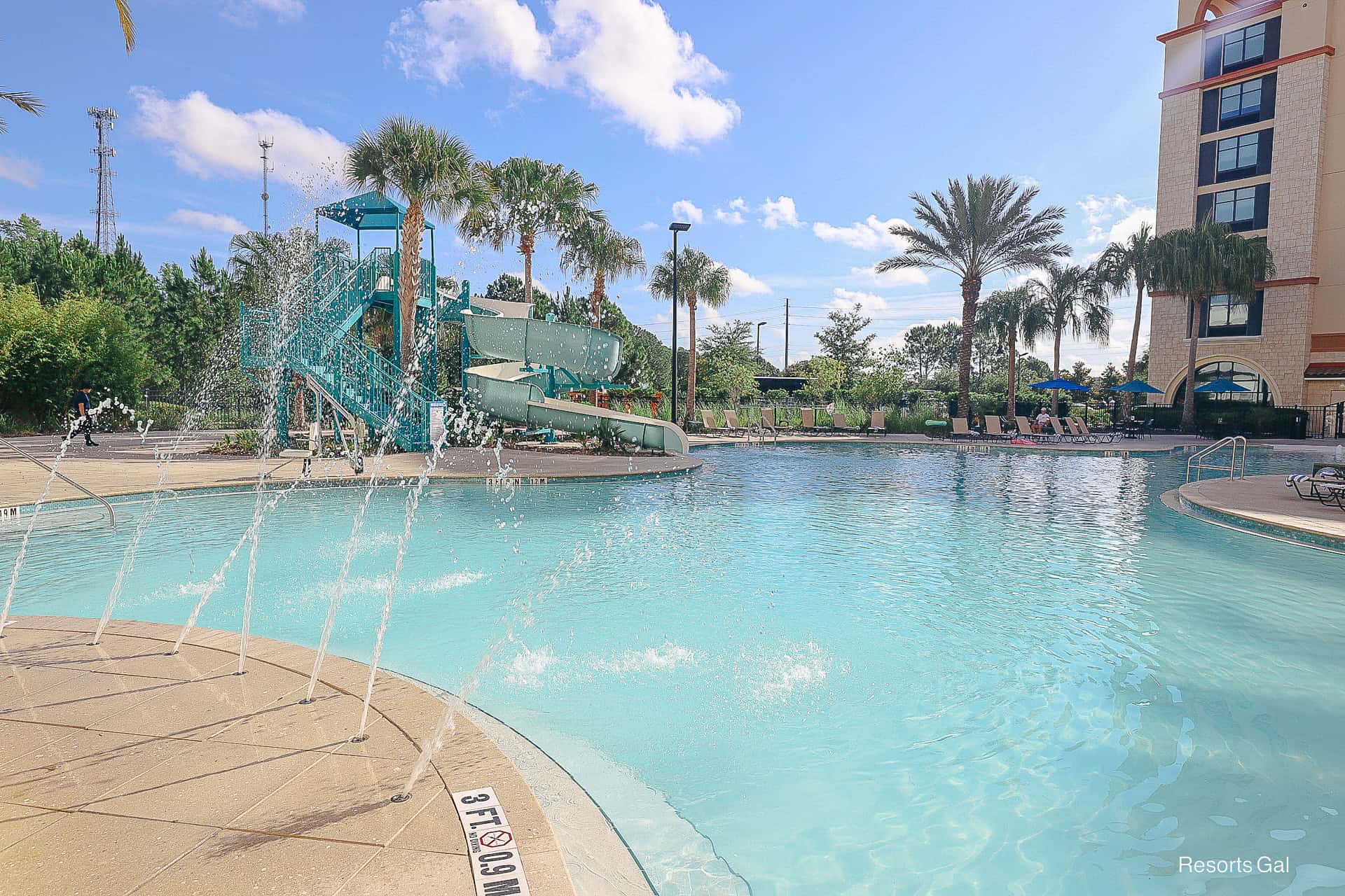 a spray element on one side of the pool
