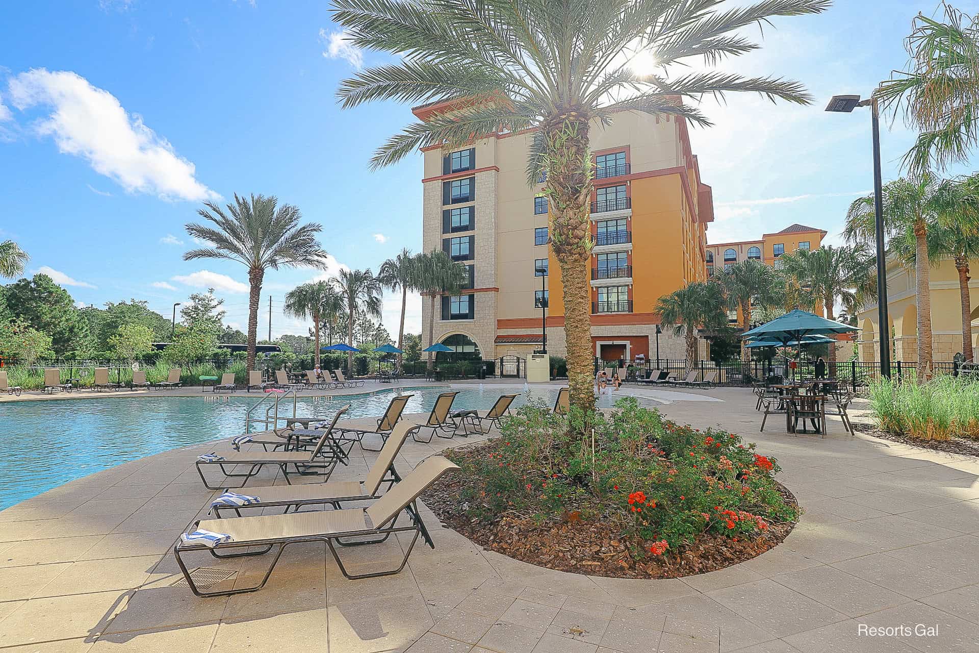 a couple of chairs sitting near the pool at Home2 Suites Flamingo Crossings