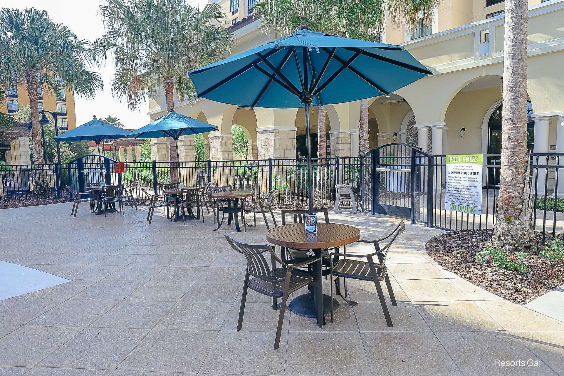 a table and chairs sitting under an umbrella