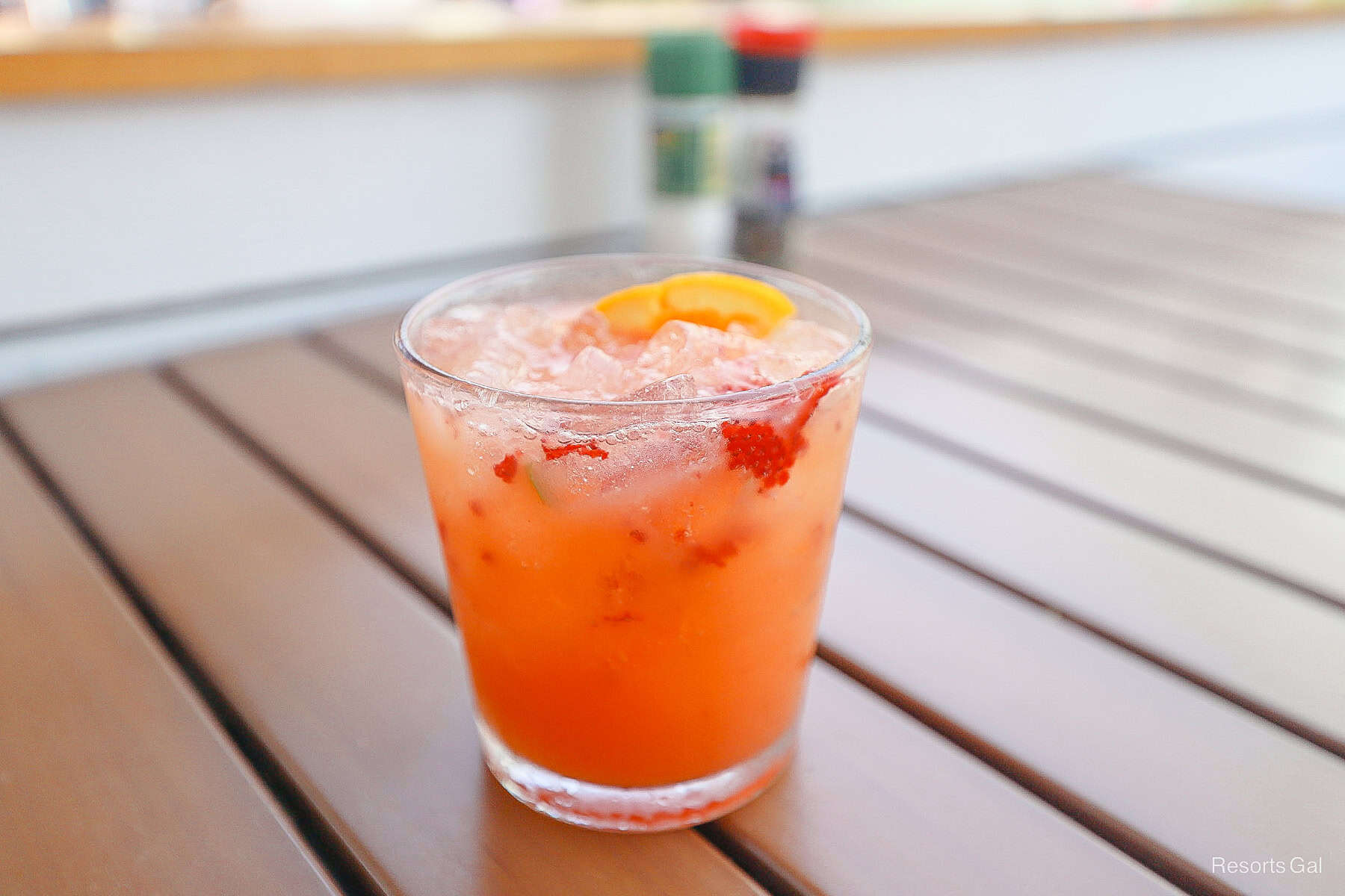 a peach colored drink in a clear glass 