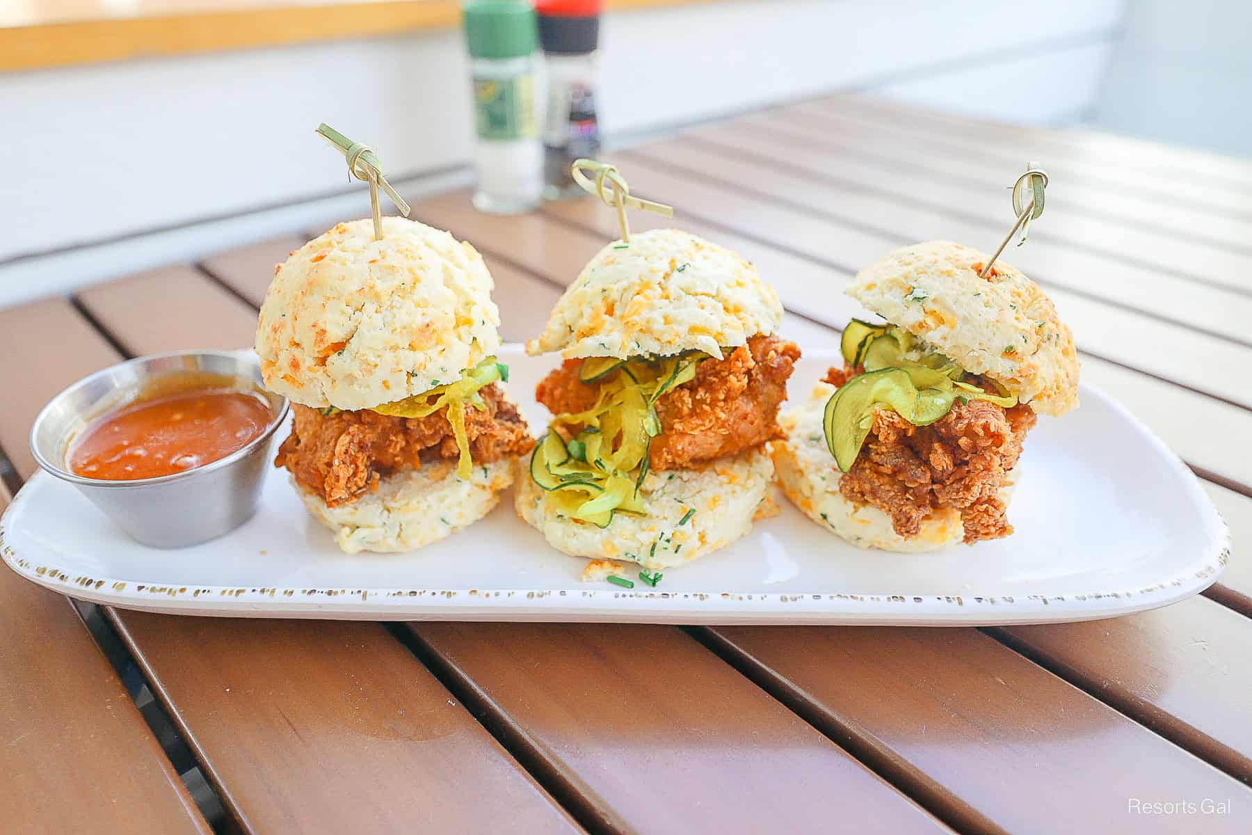 three chicken biscuits on a platter