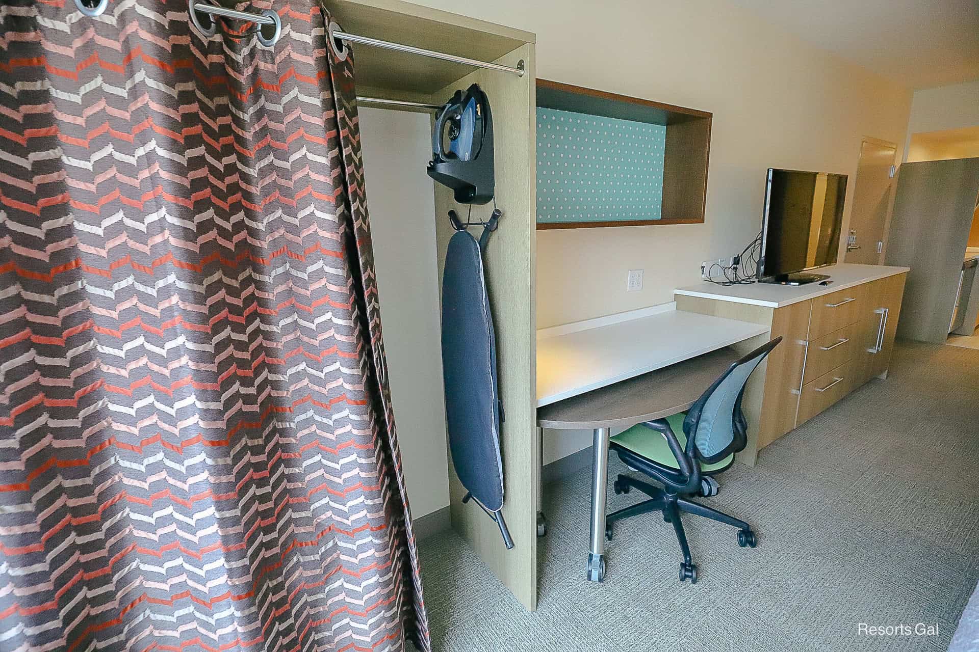 a closet with iron and ironing board in our room at the Home2 Suites by Hilton at Flamingo Crossings