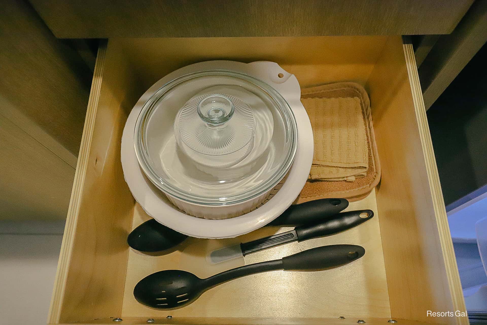 a drawer with kitchen essentials and cookware