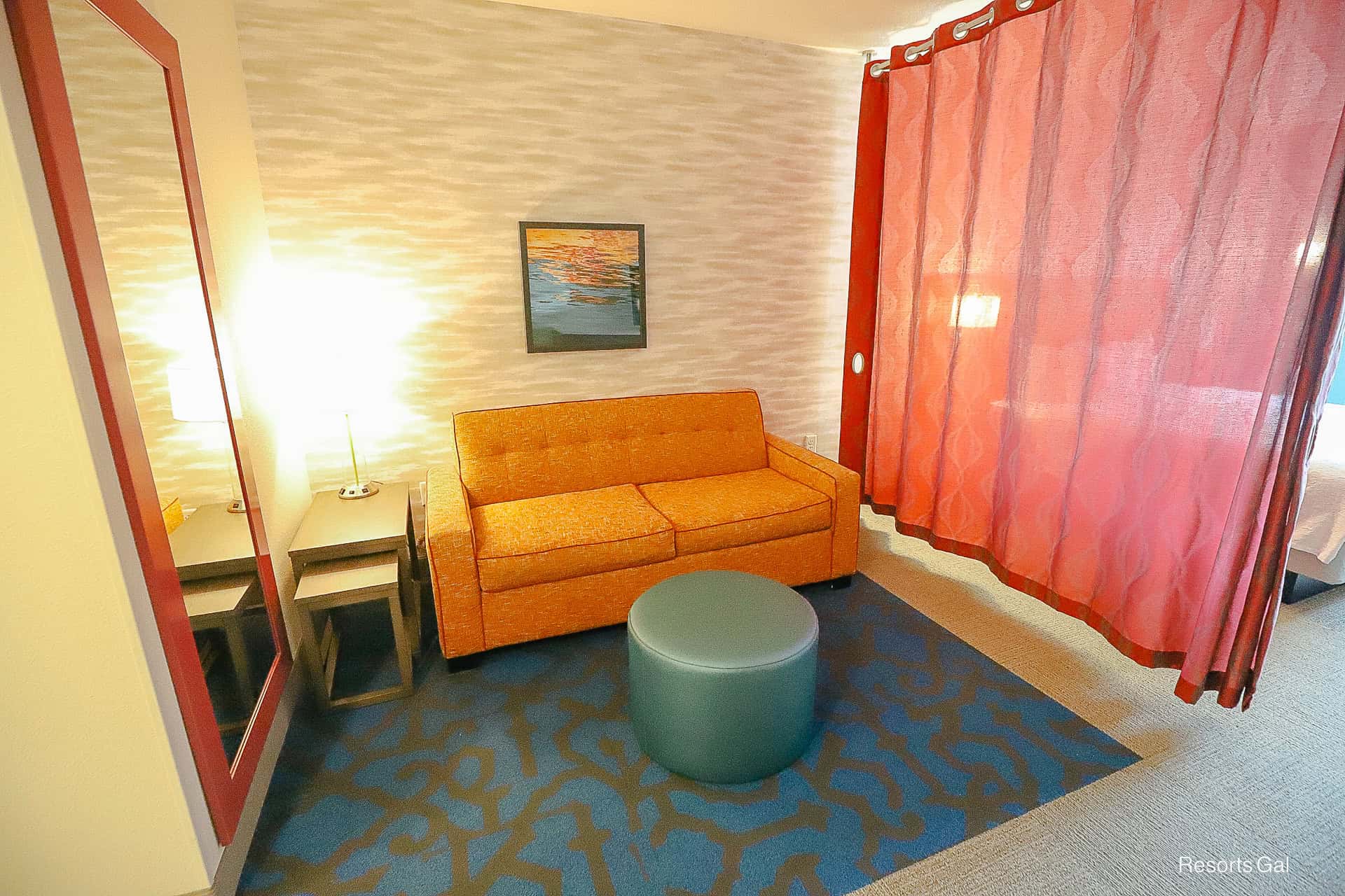 a sofa bed on one side of the room in the Home2 Suites Hilton Flamingo Crossings