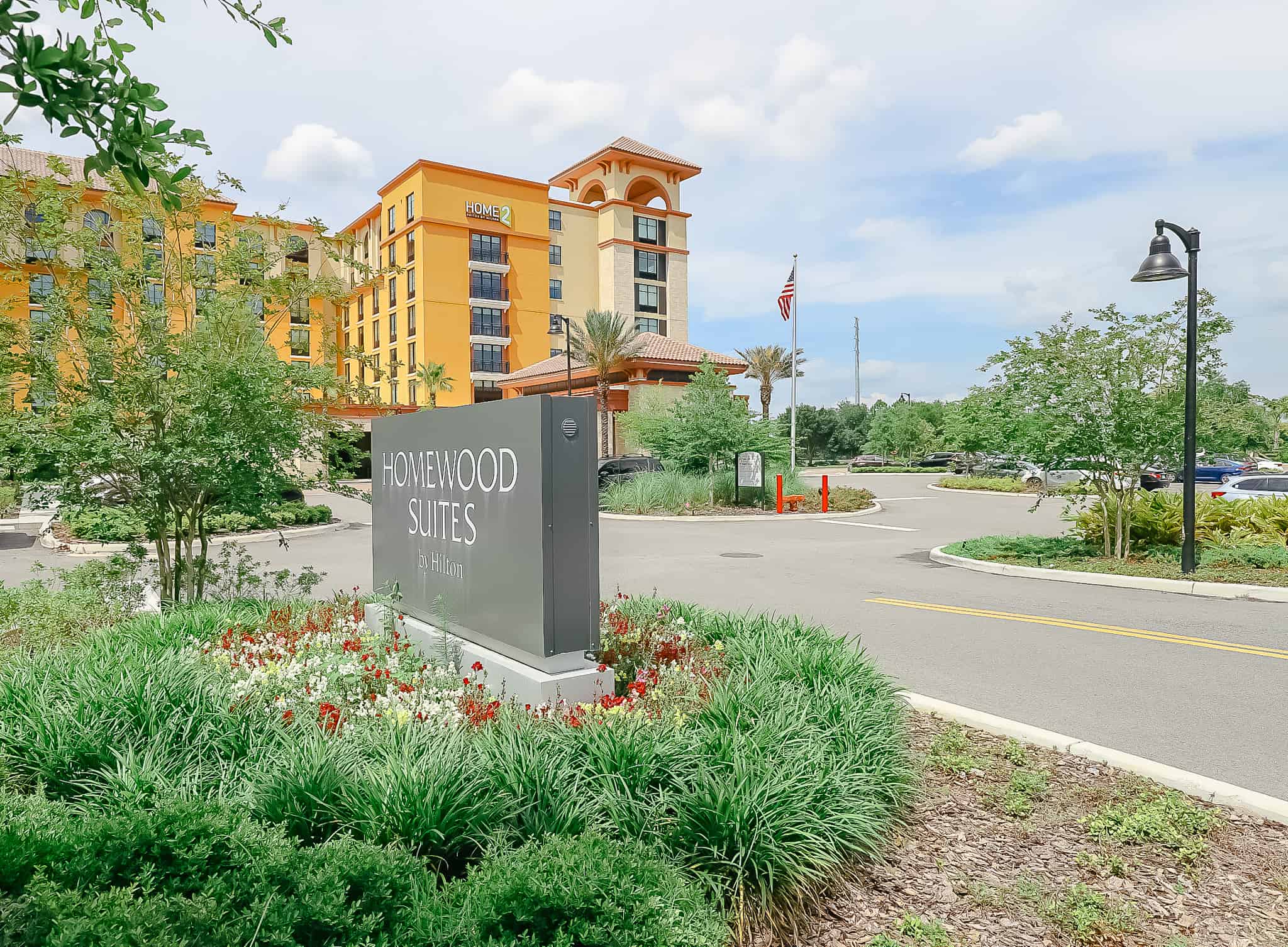 The Homewood Suites at Flamingo Crossings is a yellow and tan buildings with a clay roof. 