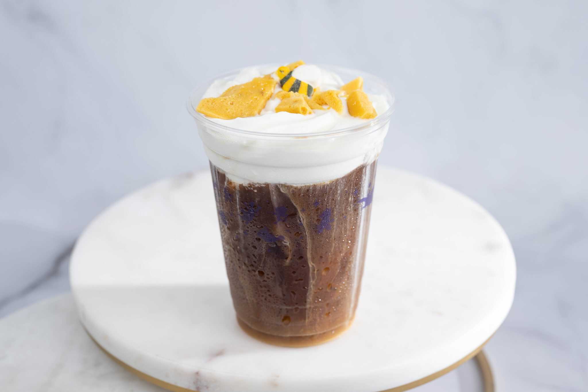 a cold brew in a clear Joffrey's cup with foam and honeycomb toffee