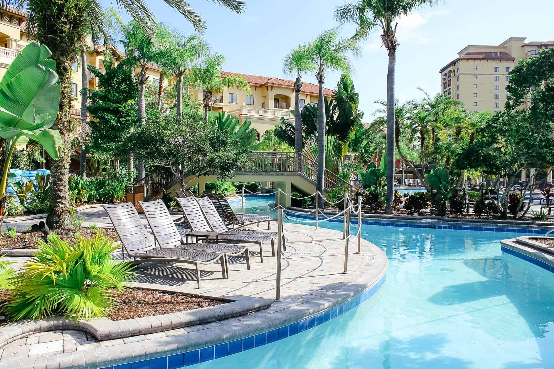 lazy river with lounge chairs in front of one of the towers at Wyndham Bonnet Creek near Disney World. 