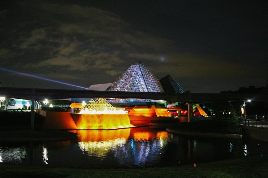 The Imagination Pavilion at night with the fountains lit up. 