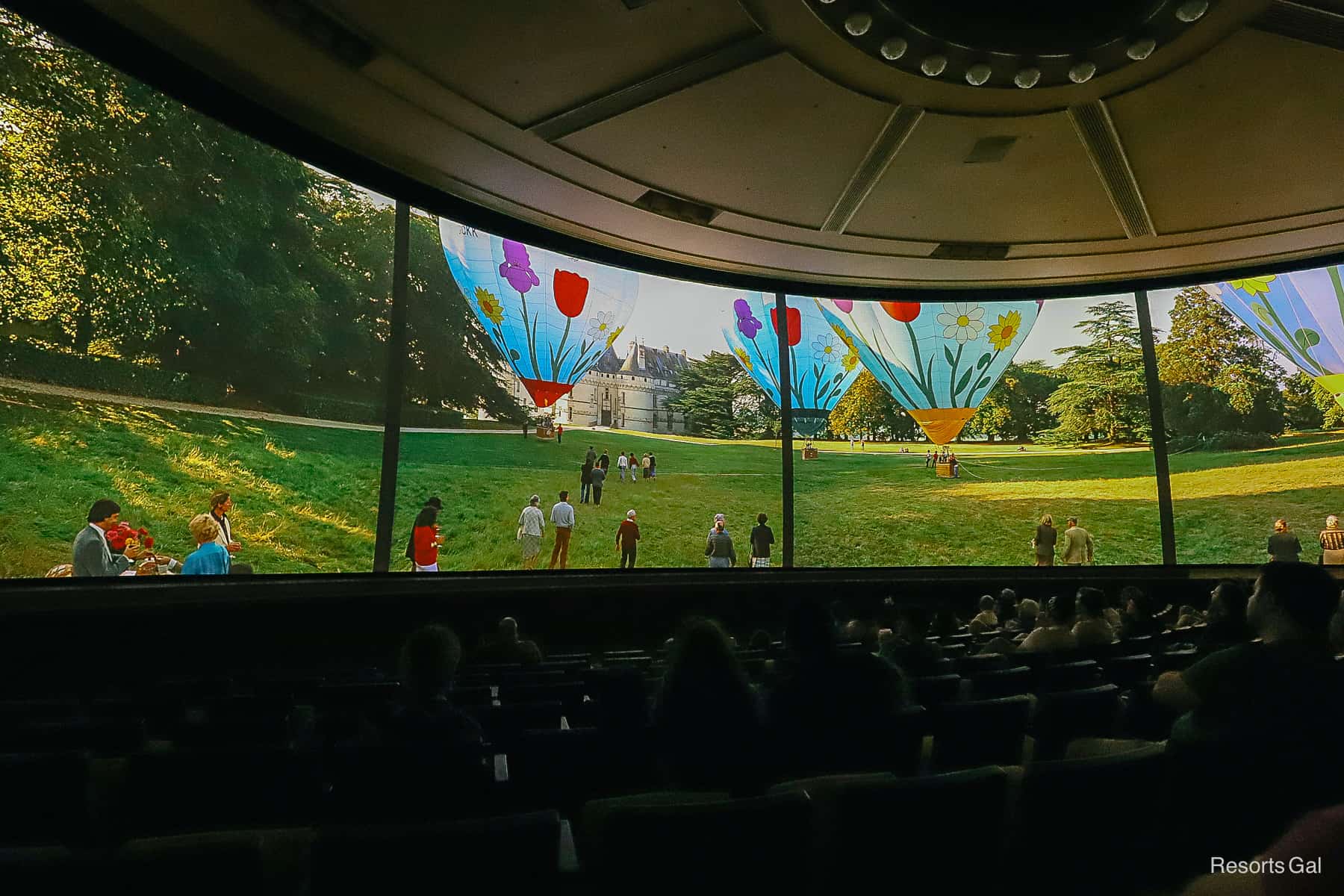 Hot air balloons preparing to take flight in blue colors with Spring flowers