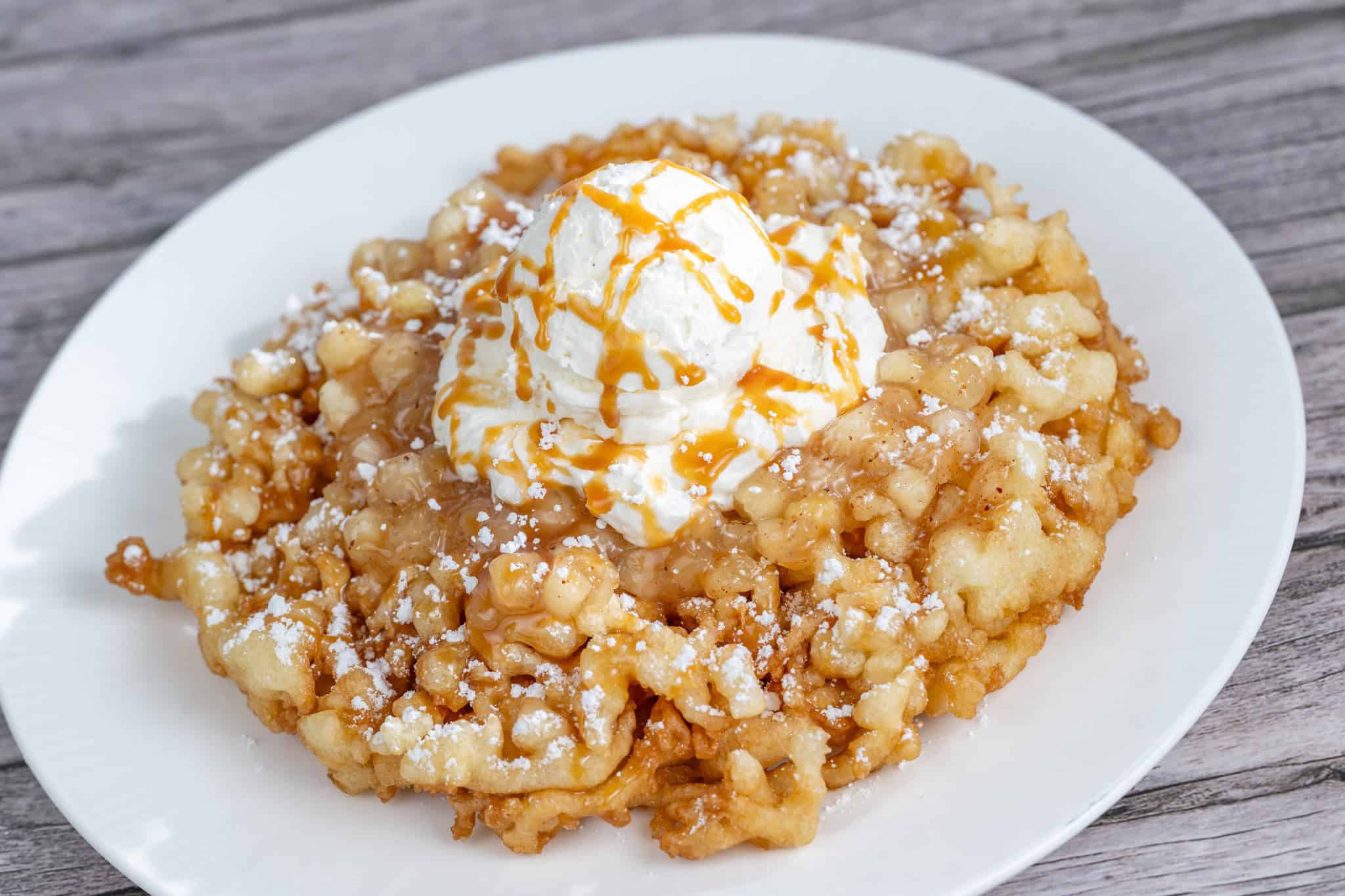 a funnel cake topped with apple pie