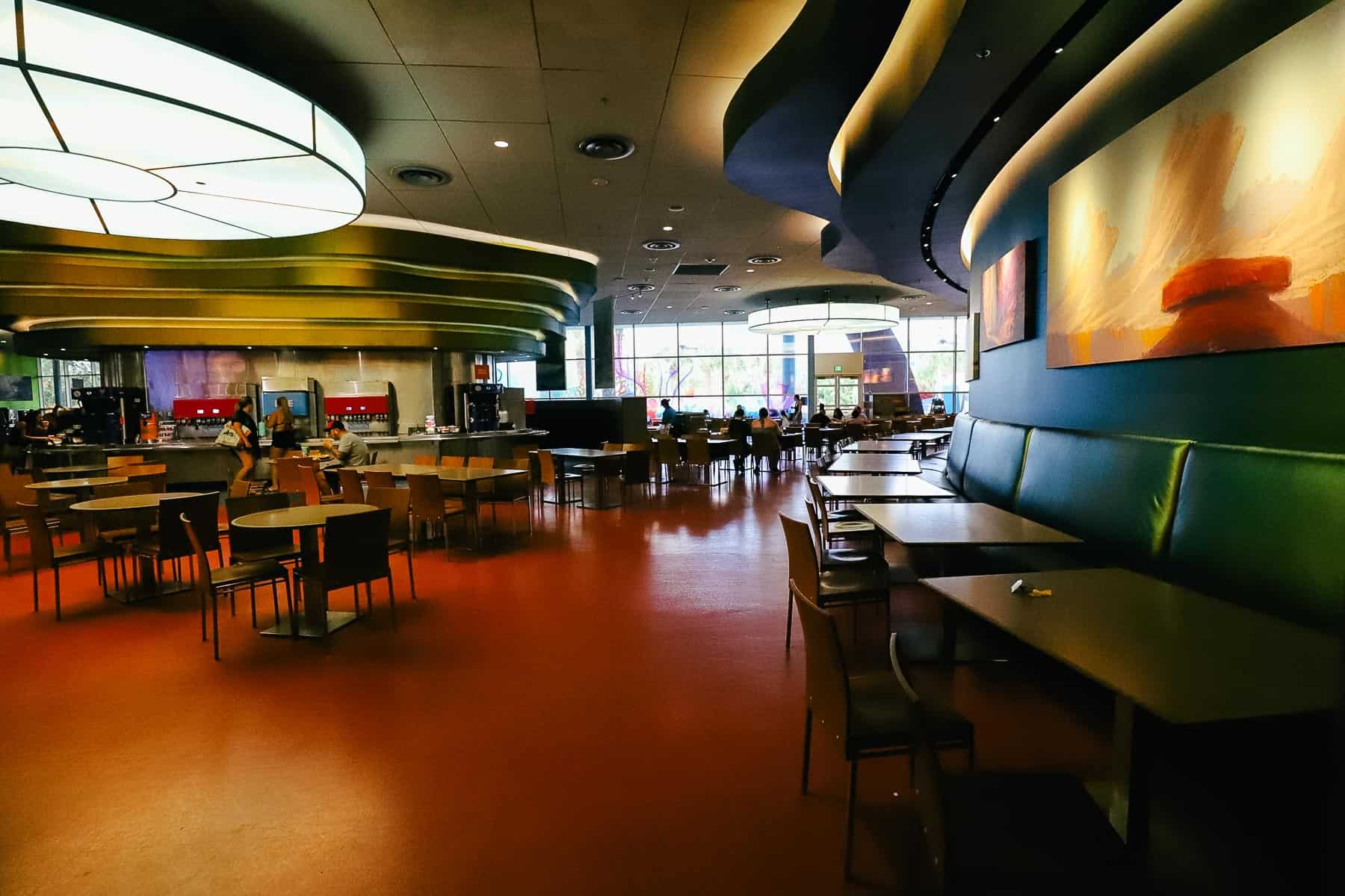 a row of banquette style seating with chairs on the opposite side of the table 