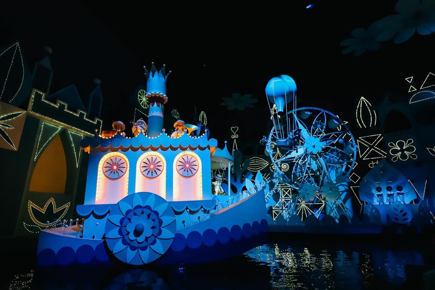 dolls on a boat and ferris wheel 