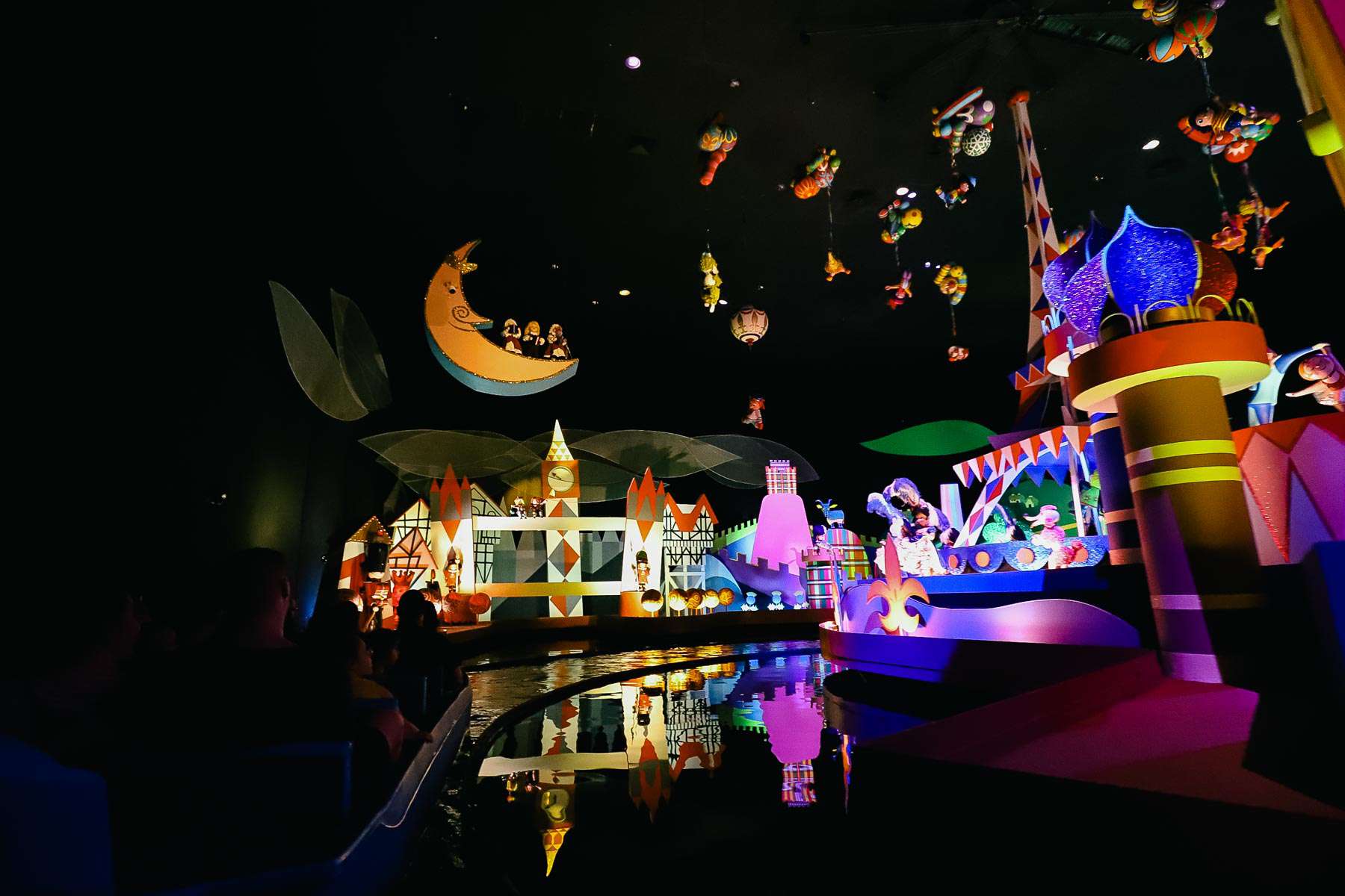 "it's a small world" moon scene with dolls hanging overhead. 