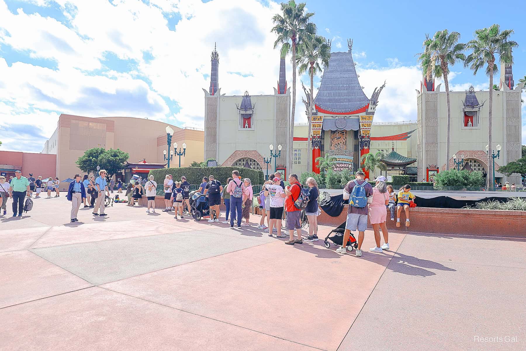 a line of guests waiting in the area where Pinocchio and Jiminy Cricket rotate a meet-and-greet
