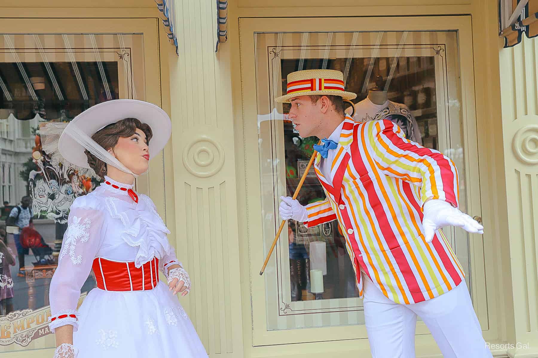 Mary Poppins and Bert in their Jolly Holiday costumes, a white dress with red trim and a bright striped suit