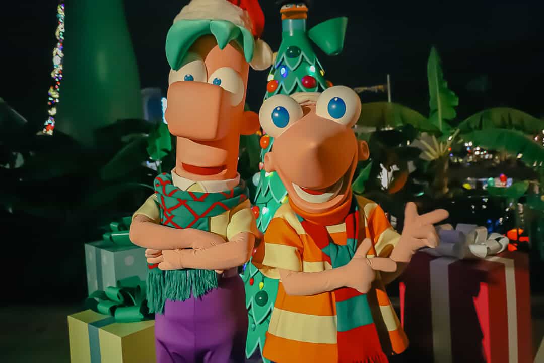 Phineas and Ferb wearing their usual outfits with holiday scarves at Jollywood Nights.